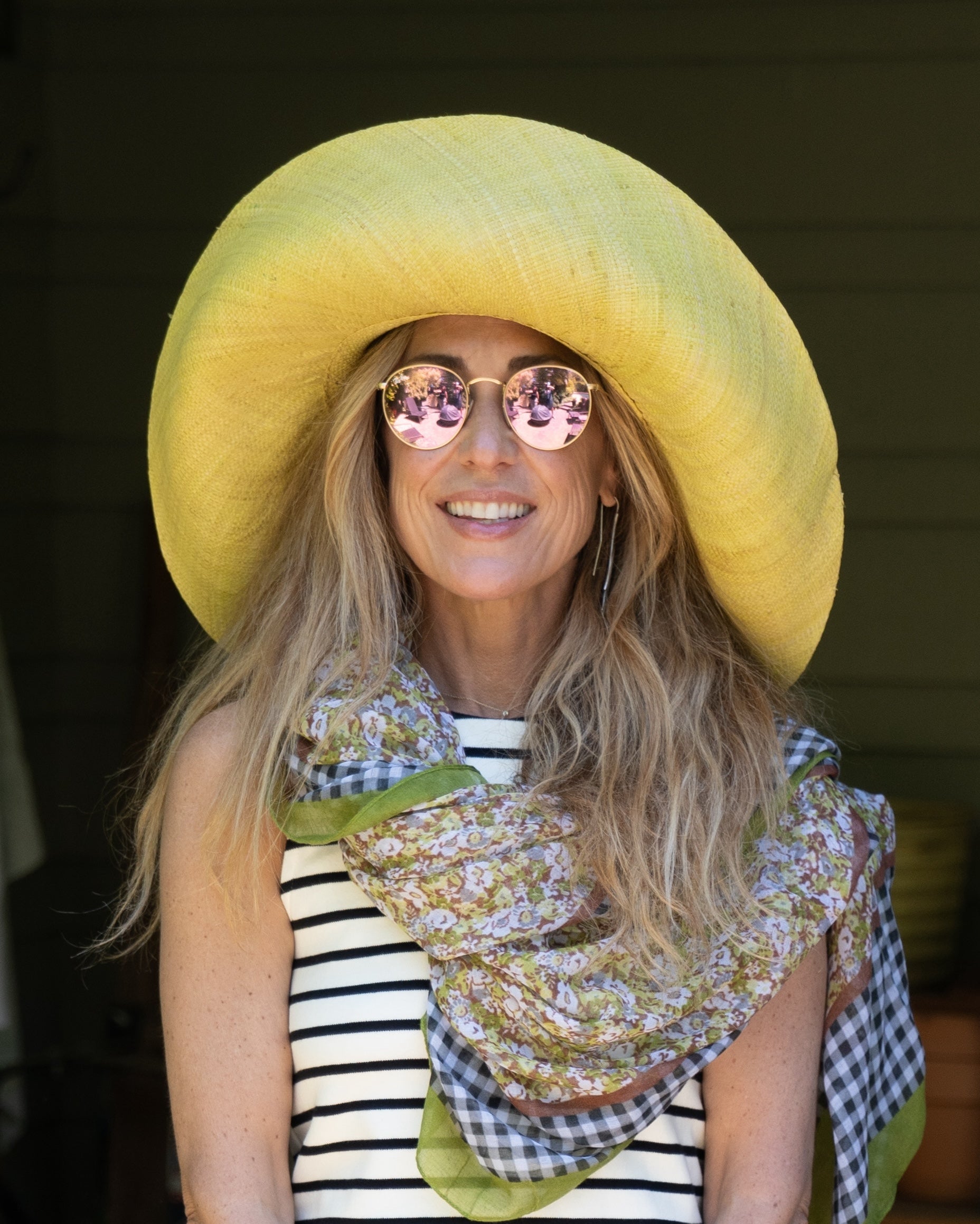 Model wearing Monica 5" & 7" Wide Brim Solid Color Packable Straw Sun Hat handmade loomed raffia in a solid hue of butter light/yellow - Shebobo (with French Country Floral & Gingham Scarf)