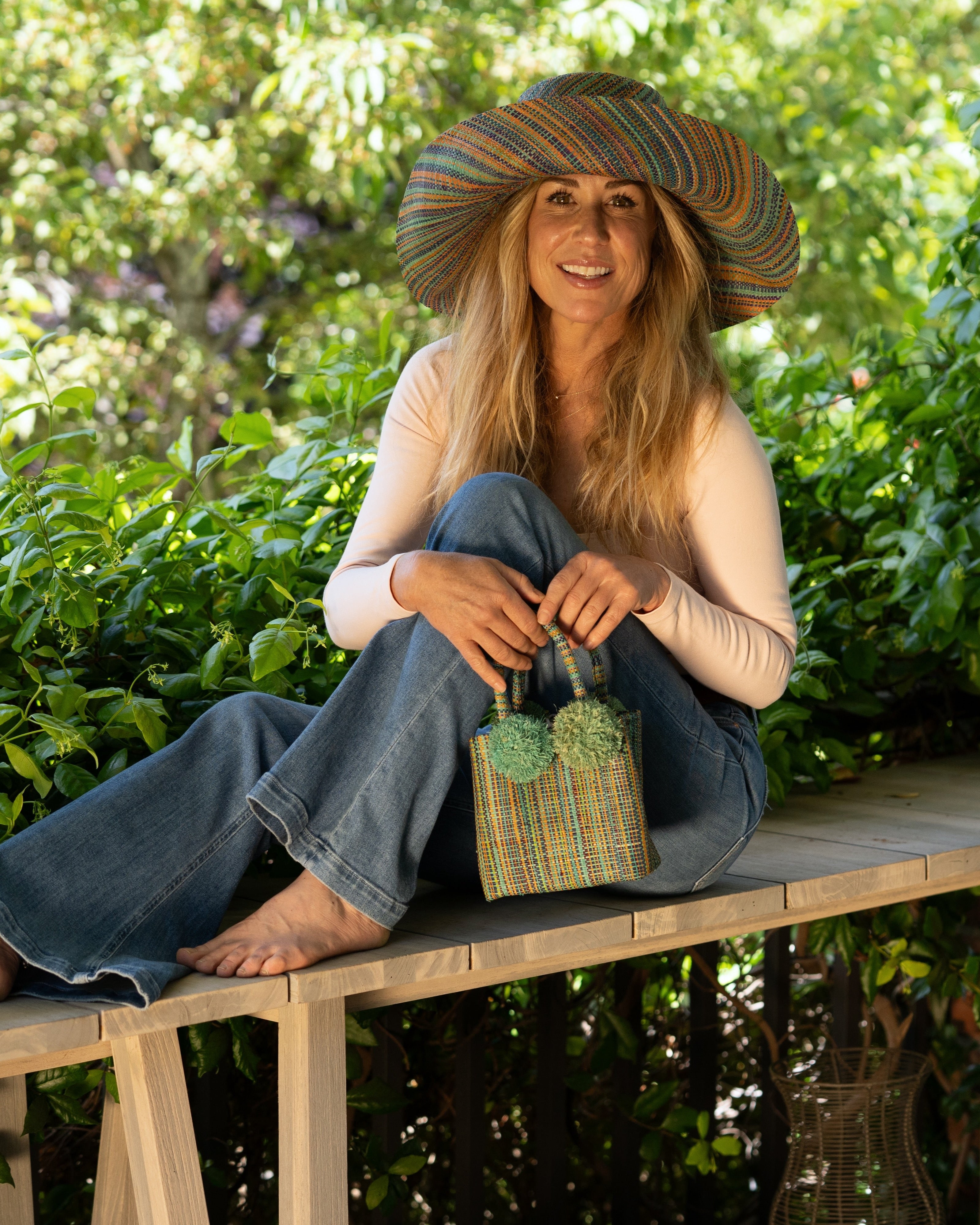 Model wearing Monica 5" Wide Brim Seafoam Multi Melange Packable Straw Sun Hat multicolor heather pattern of seafoam blue/green, lime green, turquoise blue, yellow, navy blue, pink, fuchsia, coral orange/red, natural straw color, etc. - Shebobo (with Schooner Straw Mini Bag)
