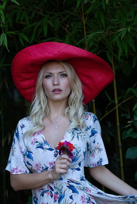 Model wearing Monica 7" Wide Brim Natural Packable Straw Sun Hat handmade loomed raffia in a solid hue of blue lightweight malleable flexible sun protection hat - Shebobo