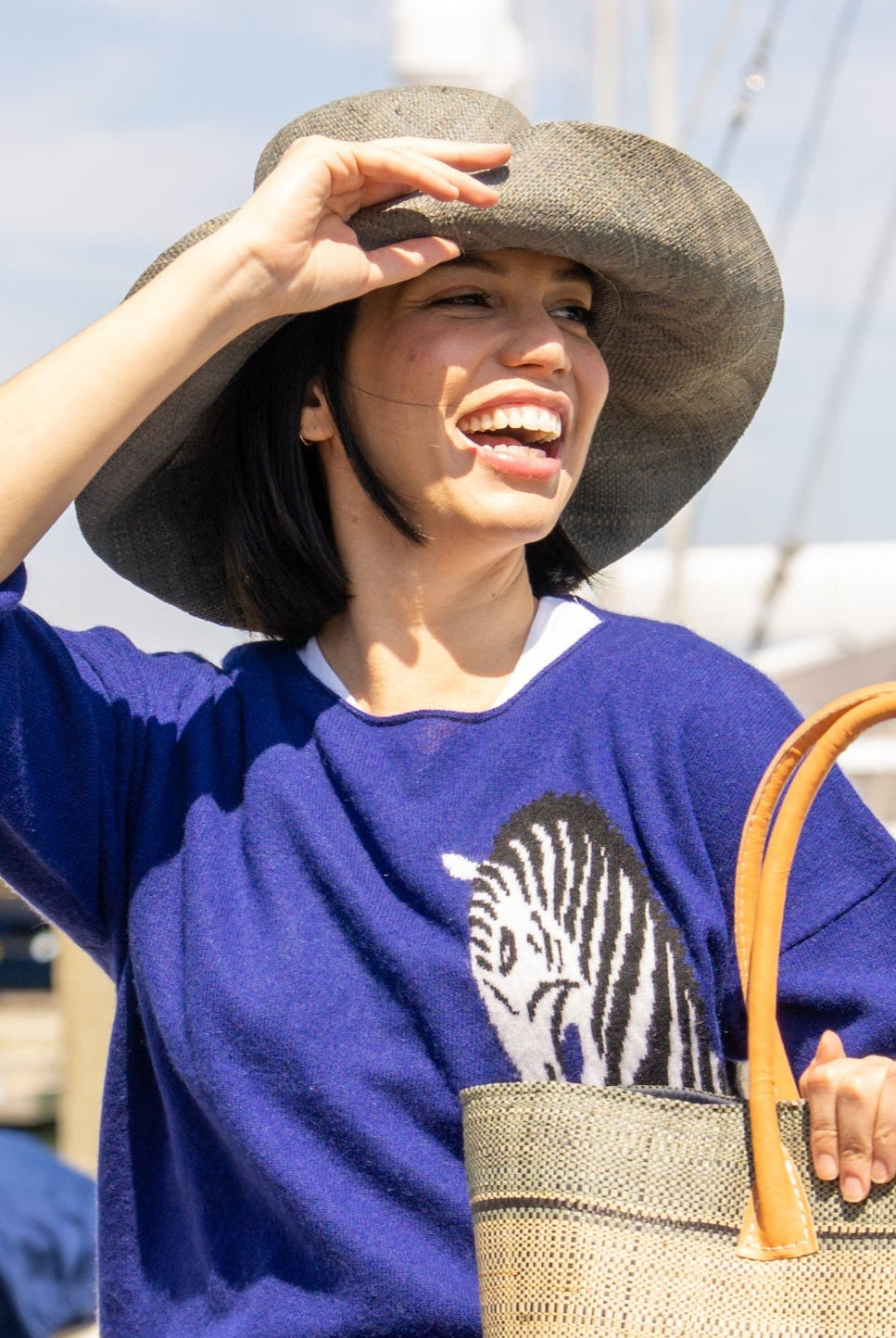 Model wearing Monica 5" Wide Brim Grey Packable Straw Sun Hat handmade loomed raffia in a solid hue of grey lightweight malleable flexible sun protection hat - Shebobo