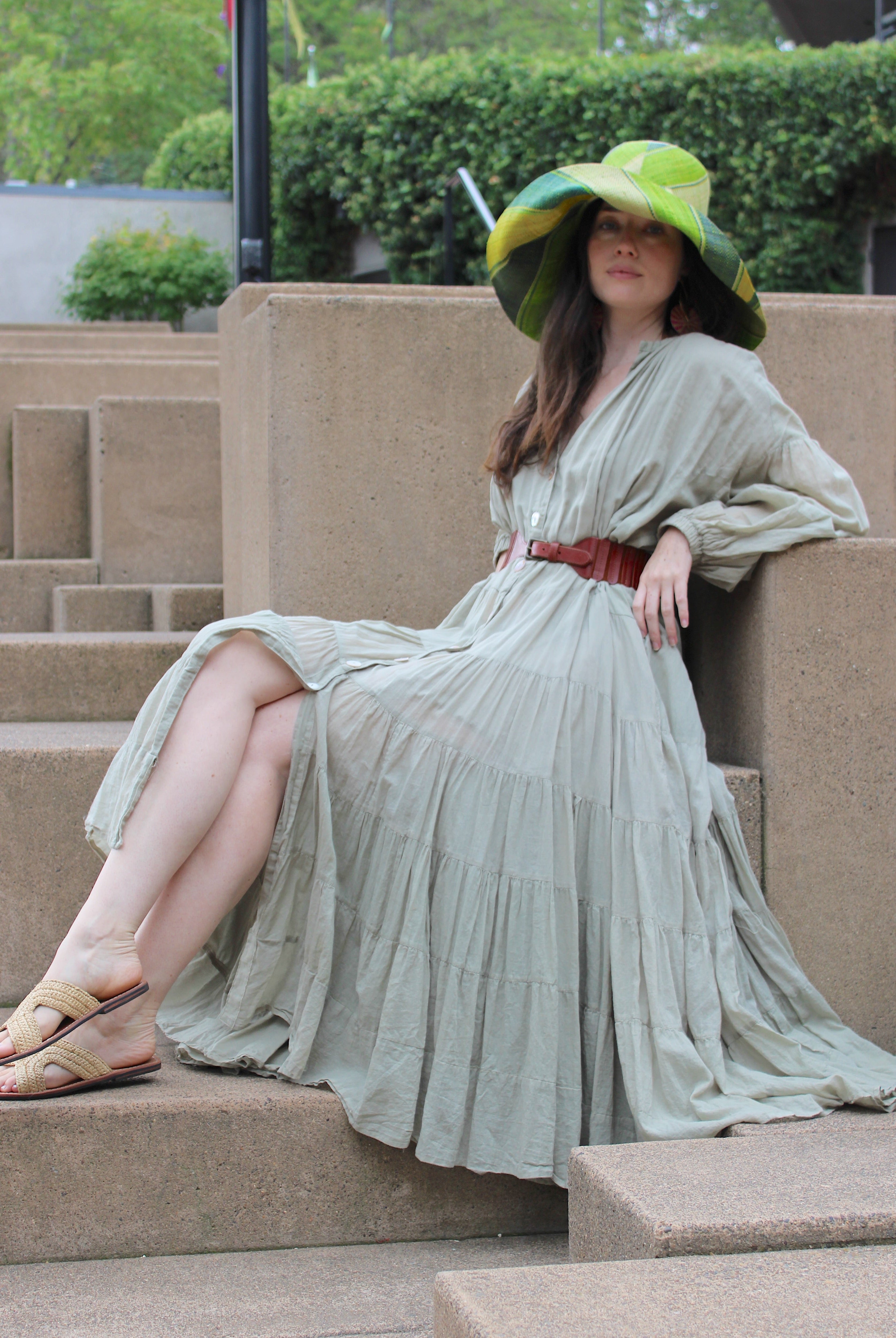 Model wearing Monica 7" Wide Brim Izarra Swirl Multicolor Stripes Packable Straw Sun Hat Handmade loomed raffia in multi width bands of midori lime/green, teal, dusk navy/dark/blue, yellow, natural straw color etc. create a swirl pattern - Shebobo