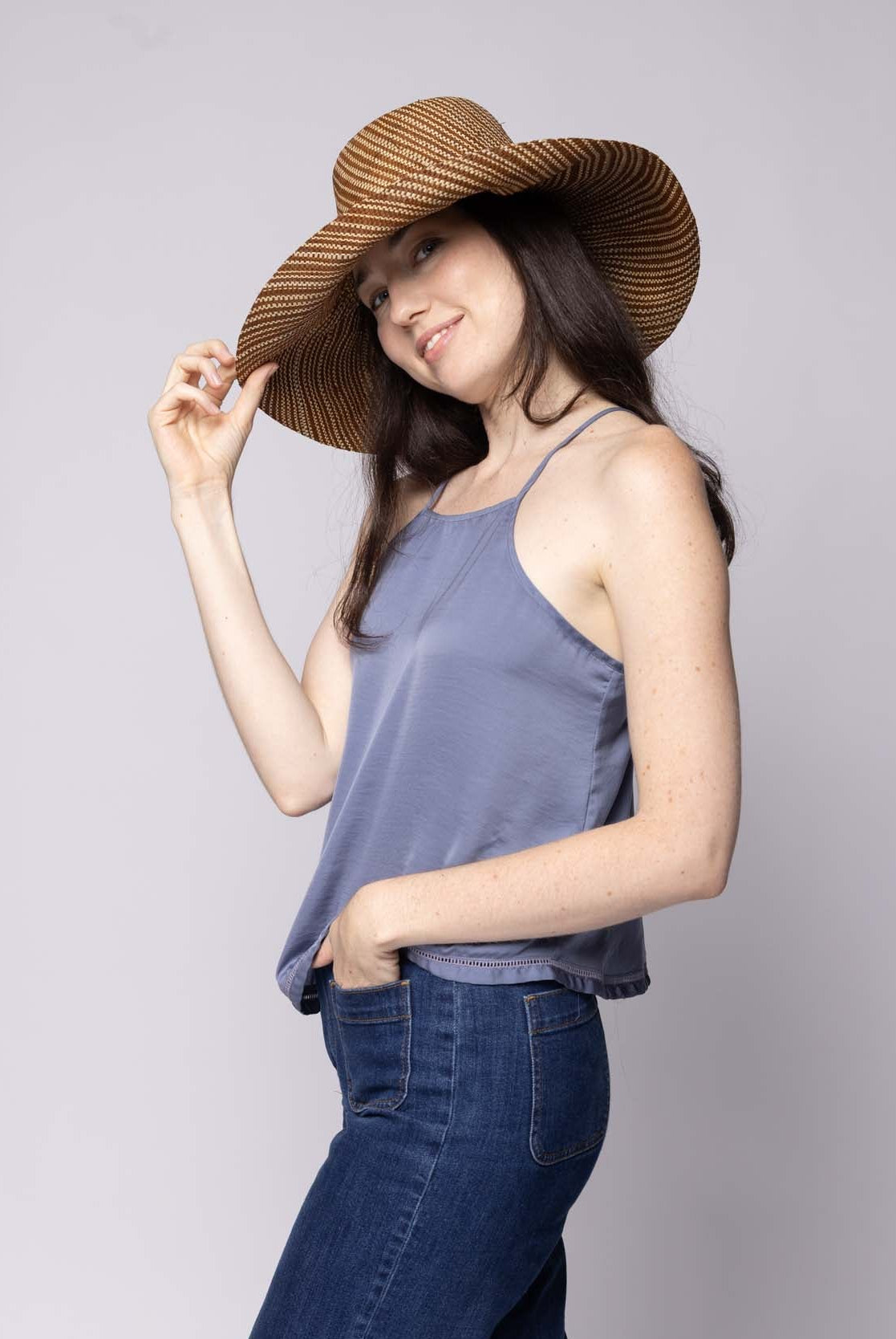 Model wearing Monica 5 inch or 7 inch Wide Brim Tobacco Two Tone Melange Packable Straw Sun Hat handmade loomed raffia in a multicolor heathered melange pattern of tobacco dark/cinnamon/brown and natural straw color creates a subtle swirl - Shebobo