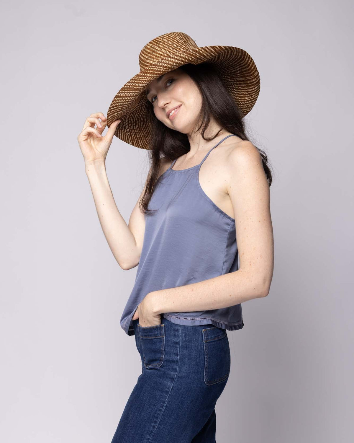 Model wearing Monica 5 inch or 7 inch Wide Brim Tobacco Two Tone Melange Packable Straw Sun Hat handmade loomed raffia in a multicolor heathered melange pattern of tobacco dark/cinnamon/brown and natural straw color creates a subtle swirl - Shebobo