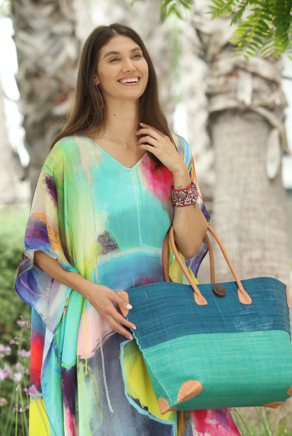 Model wearing Model wearing Monterey Two Tone Straw Tote Bag handmade loomed raffia fibers in a color block pattern of turquoise blue colored upper half, and seafoam blue/green lower half - Shebobo