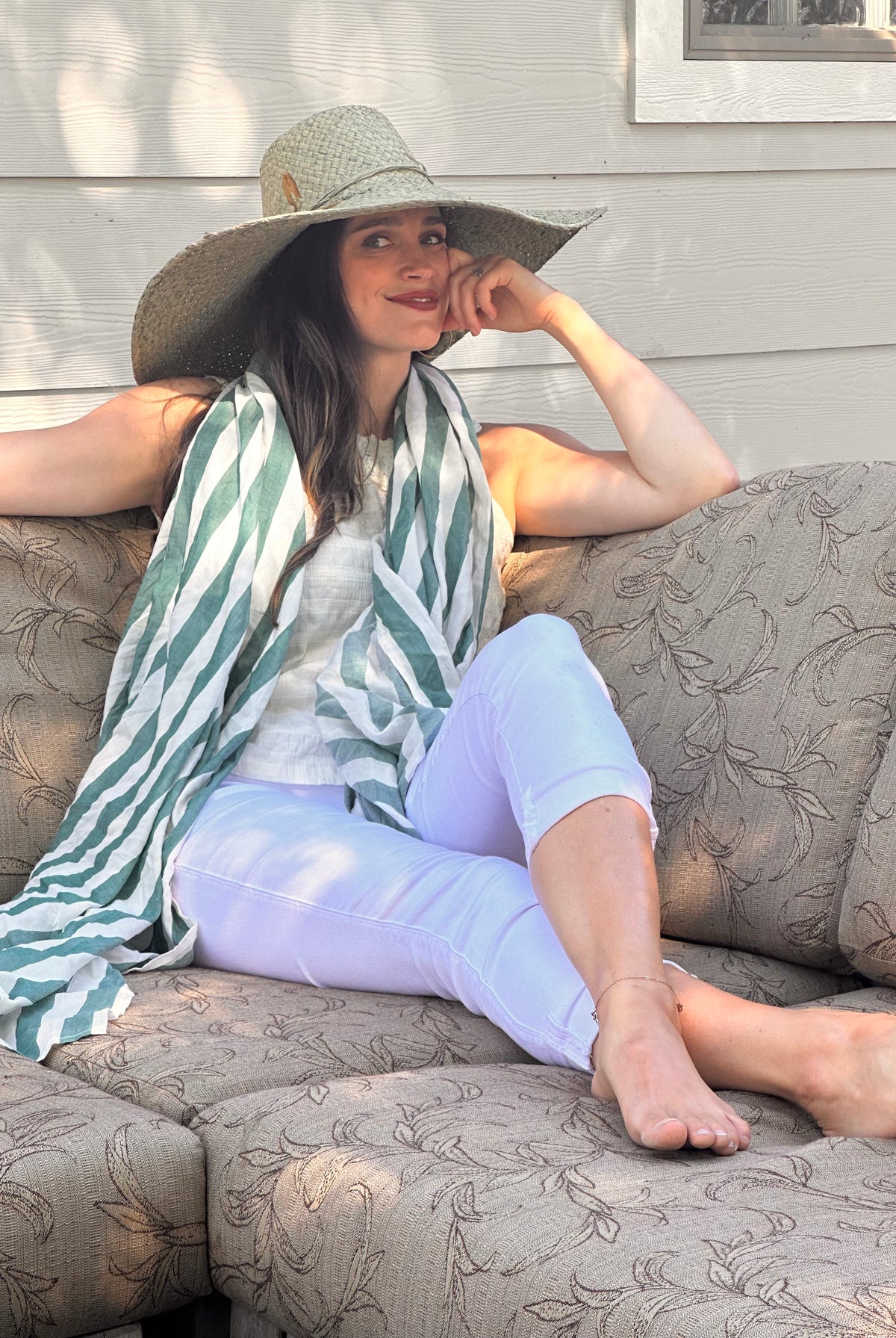 Model wearing 7" Wide Brim Natasha Ocean Mist Woven XL Straw Sun Hat handmade woven natural raffia palm fiber in a solid hue of ocean mist sage/green with matching adjustable twisted raffia hat band and and extra wide brim - Shebobo