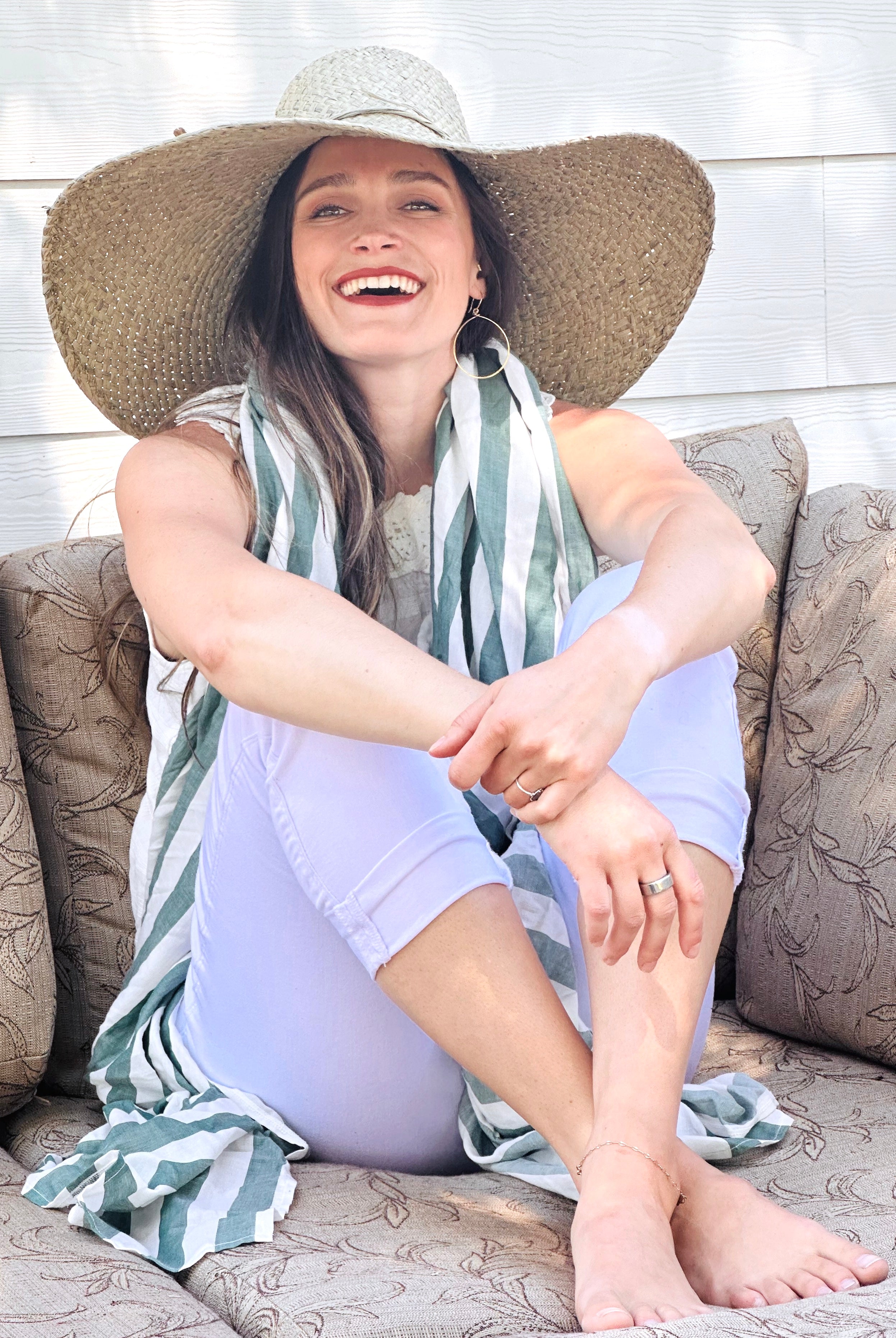 Model wearing 7" Wide Brim Natasha Ocean Mist Woven XL Straw Sun Hat handmade woven natural raffia palm fiber in a solid hue of ocean mist sage/green with matching adjustable twisted raffia hat band and and extra wide brim - Shebobo