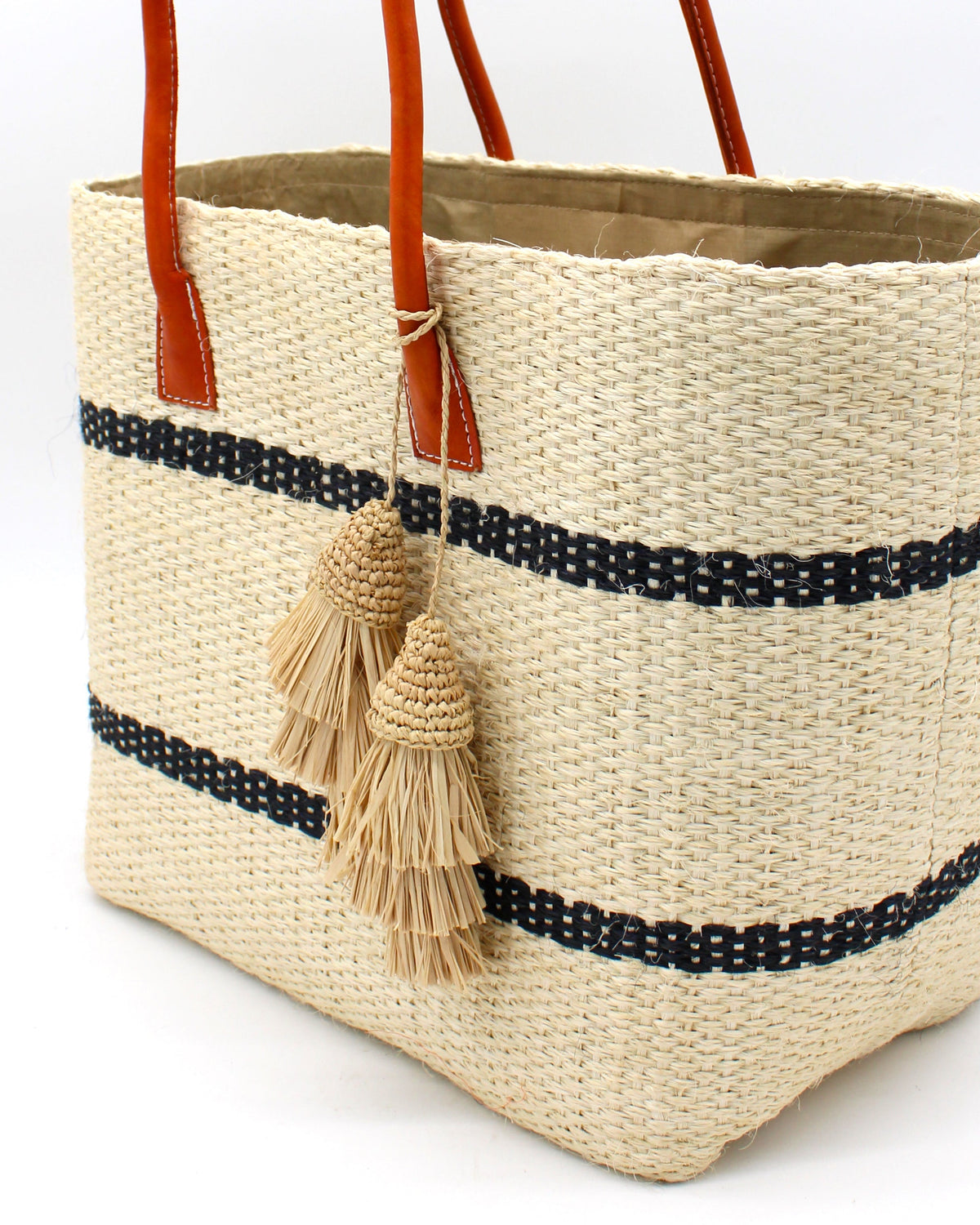 Model wearing Tassel Tie Two Layered Raffia Straw Tiered Tufts Charm Embellishment handmade crochet and brushed natural raffia palm fiber in a single hue layered tuft tassel of Natural straw color beach bag handbag charm embellishment or party decor - Shebobo