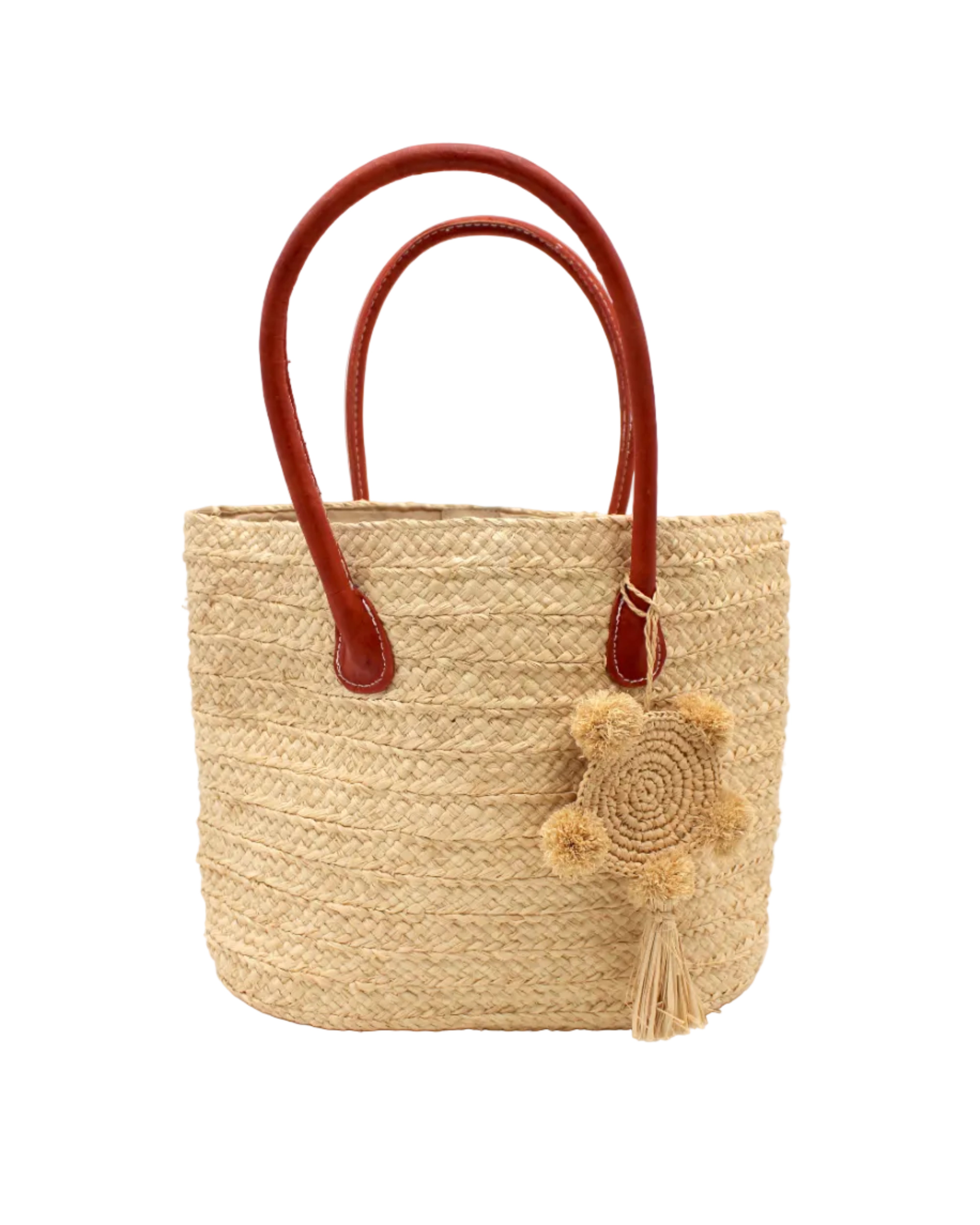 Nomena Braided Straw Basket Handbag handmade braided natural raffia palm fiber in a solid hue of natural straw color woven into concentric horizontal bands of subtle texture spiraling around the bag with leather handles beach bag shoulder bag purse with matching crochet dreamcatcher pompom and tassel charm embellishment - Shebobo