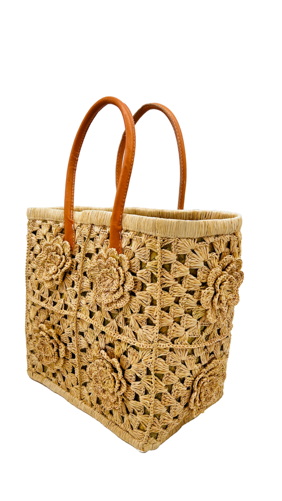 Side View Petite Flower Crochet Straw Basket handmade crochet natural raffia palm fiber in a sweet geometeric pattern of granny square type pattern with petal and raised flower detailing and leather handles - Shebobo