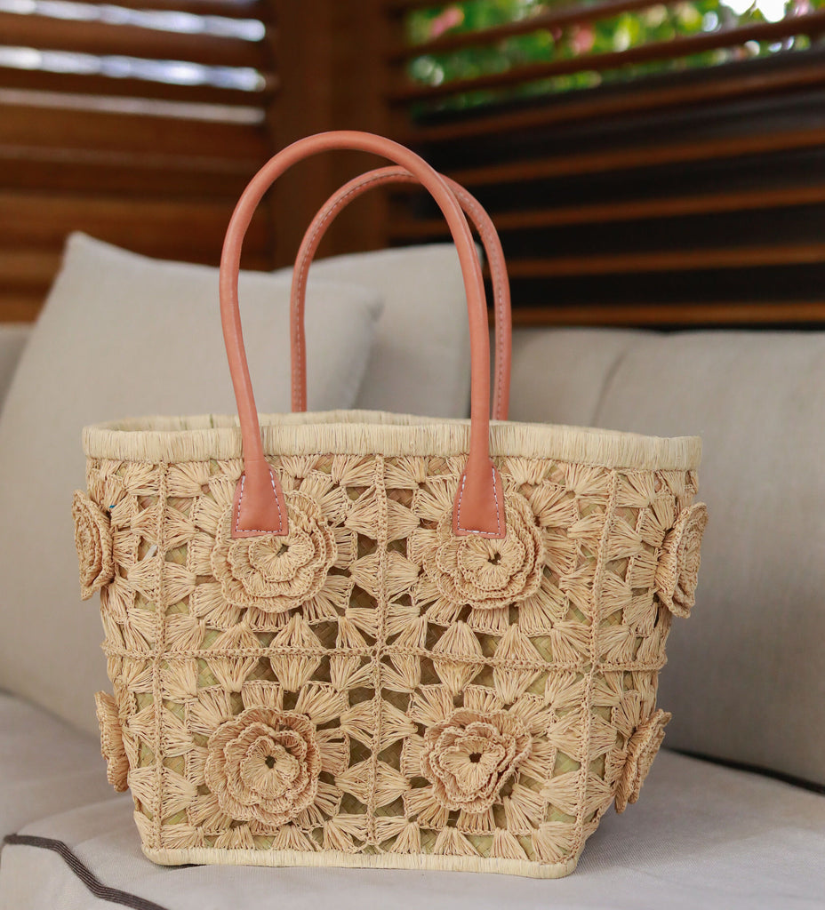 Lifestyle of Petite Flower Crochet Straw Basket handmade crochet natural raffia palm fiber in a sweet geometeric pattern of granny square type pattern with petal and raised flower detailing and leather handles - Shebobo