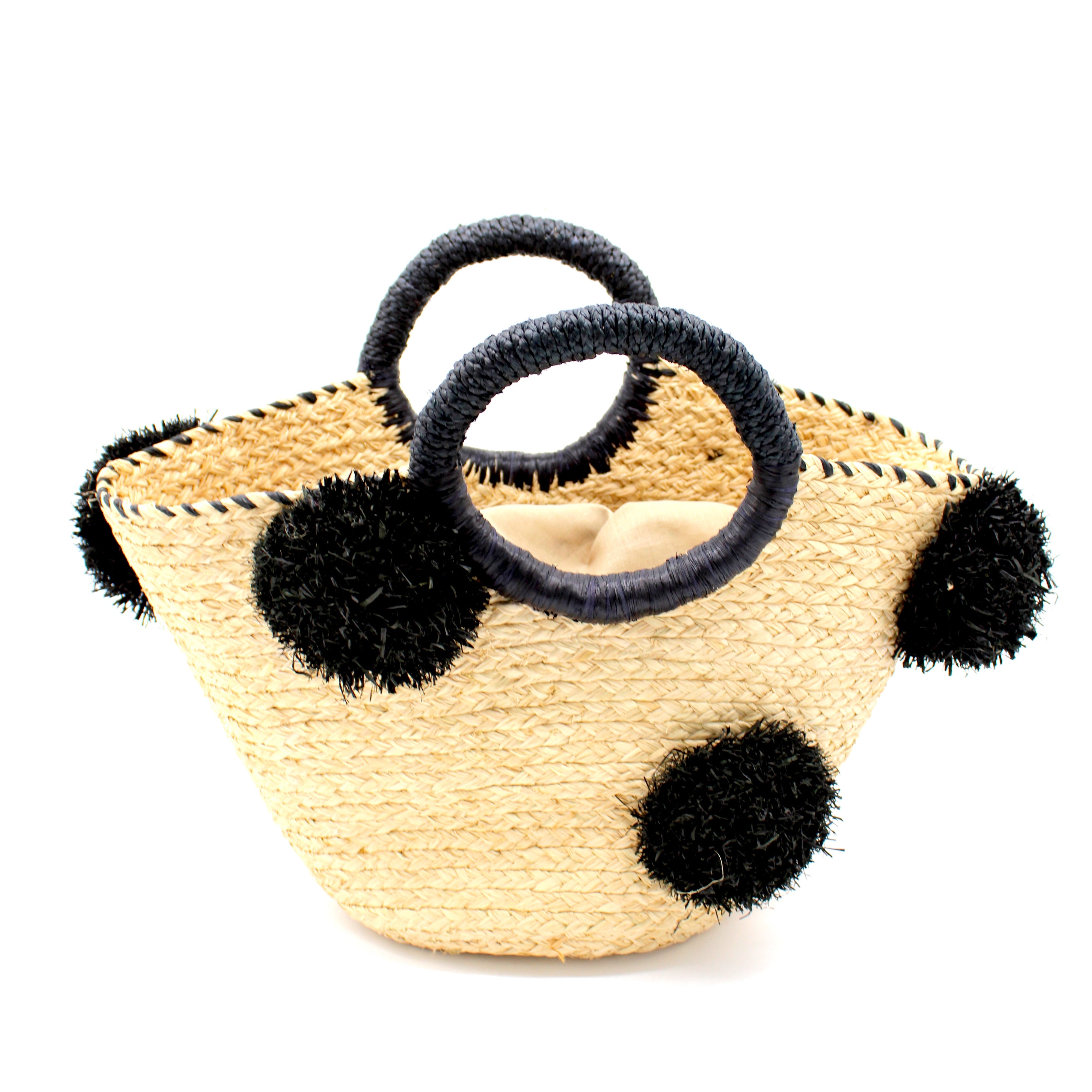 Phi Phi Black and Natural Braided Straw Basket with Oversized Raffia Poufs handmade raffia palm fiber braided into a solid hue of natural straw color with three randomly placed black hand-brushed fringe poufs per side for embellishment with matching loop wrap top edging and matching crochet loop/braided handles bag handbag - Shebobo