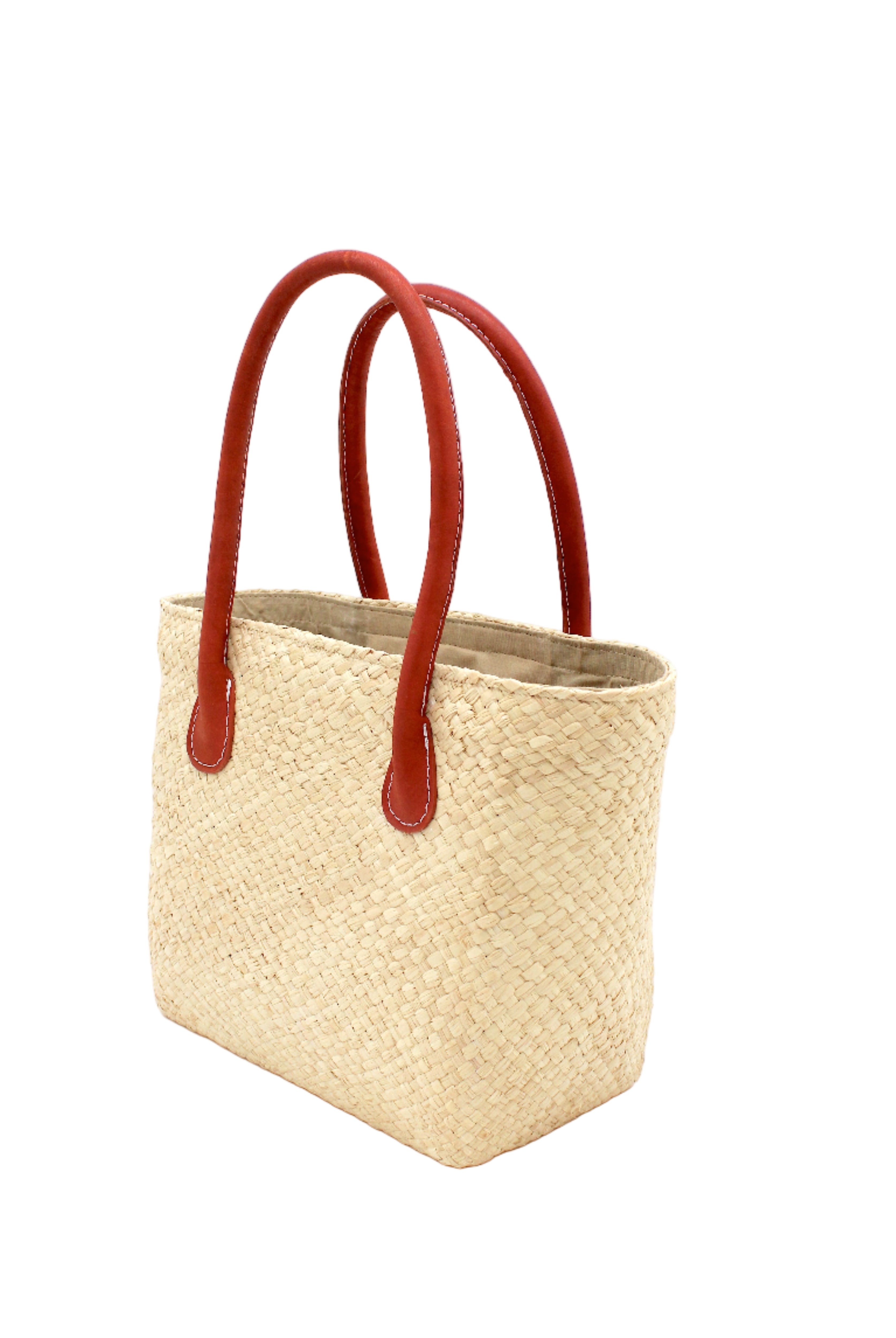Side view Pianina Natural Small Straw Basket Bag handmade from woven natural raffia palm fiber in a monochromatic cross weave pattern of natural straw color handbag purse with leather handles - Shebobo