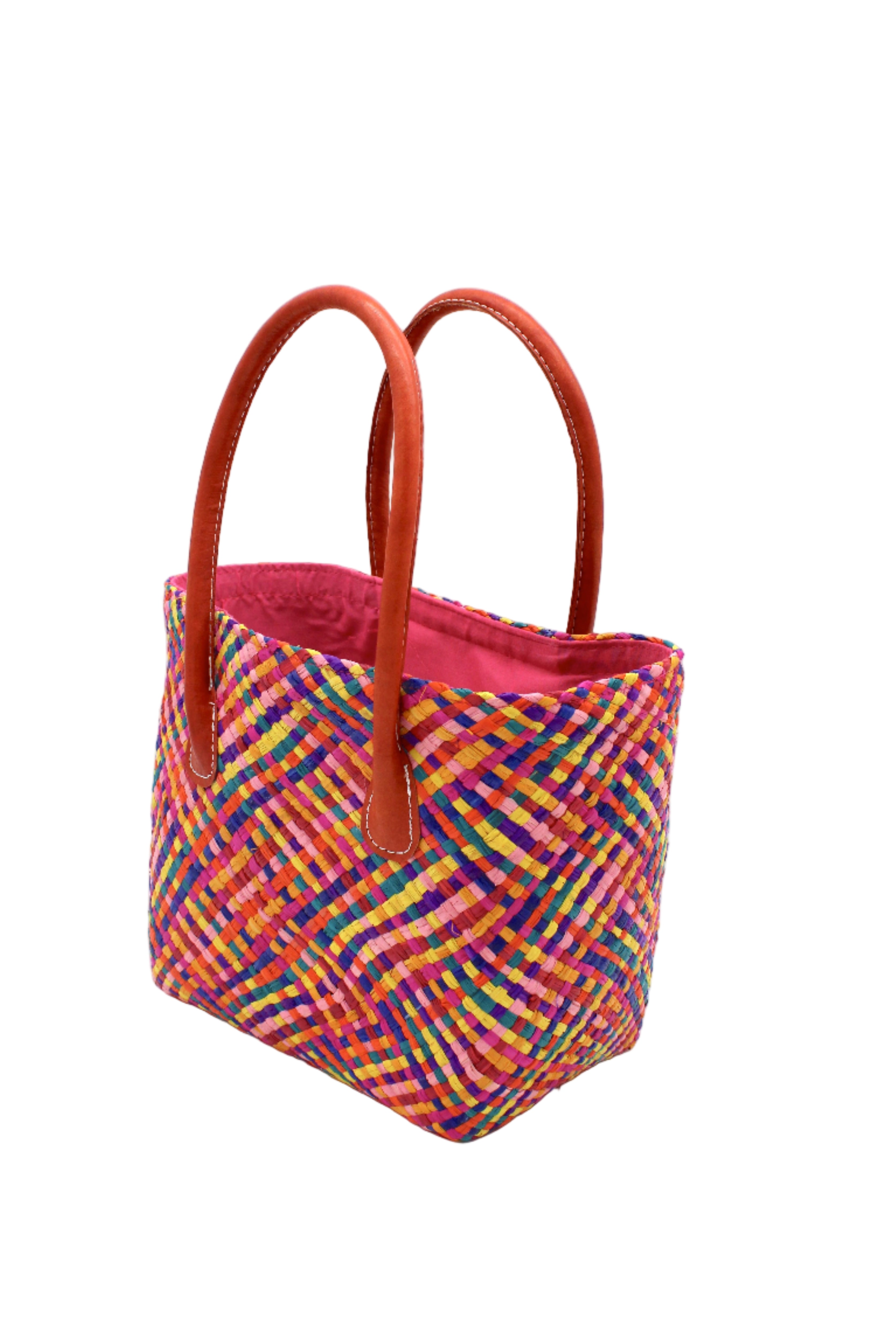 Side view Pianina Raspberry Multi Small Straw Basket Bag handmade from woven natural raffia palm fiber in a multicolor cross weave pattern of turquoise blue, coral orange, orchid purple, bordeaux red, fuchsia pink, light pink, saffron yellow, yellow, and navy blue handbag purse with leather handles - Shebobo