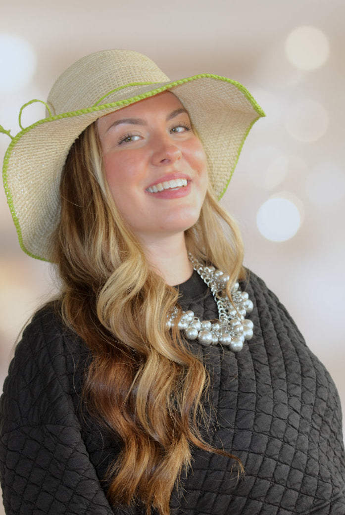 Model wearing 4 inch brim Rachel Crochet Midori handmade straw sun hat midori lime/bright/neon/green trim woven edge and matching adjustable hat band on natural straw colored raffia hat - Shebobo