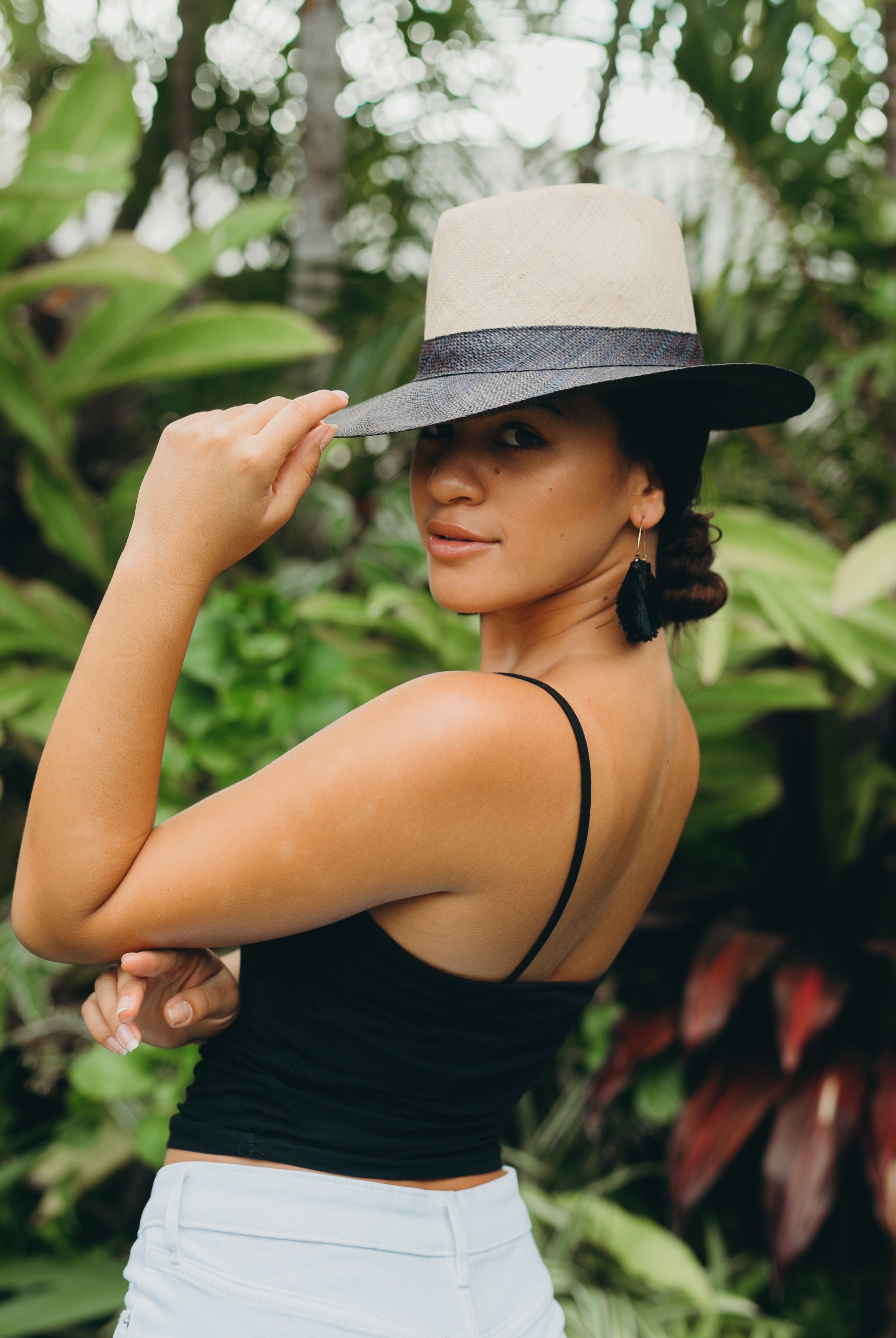 Model wearing Riley 3" Brim Panama Unisex Two Tone Straw Hats handmade loomed raffia palm fiber in a solid hue of natural straw color on the crown and solid black on the brim with matching attached hat band lightweight breathable uv/sun protection straw sun hat - Shebobo