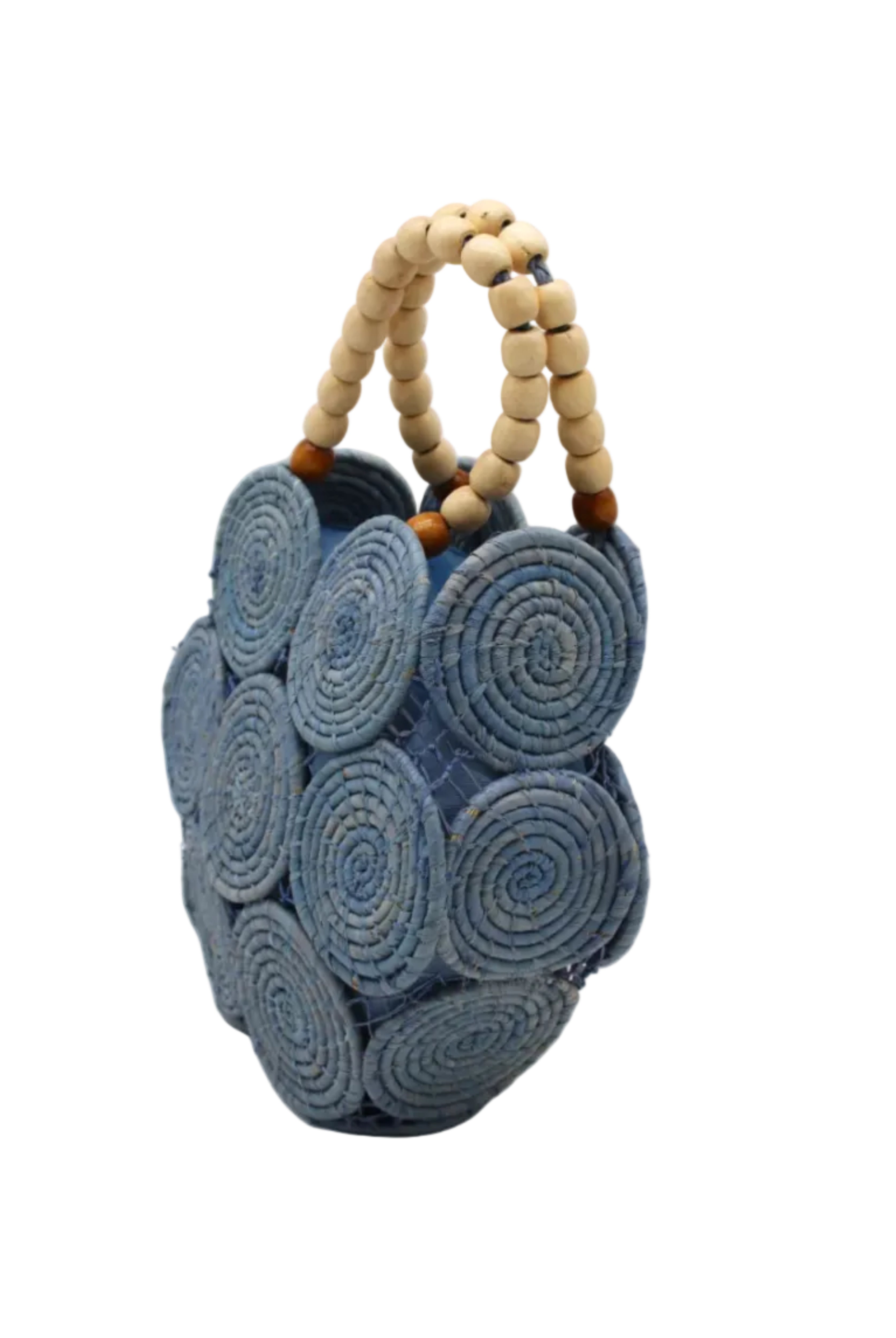 Side view Romy Denim Crochet Disc Straw Handbag with Wooden Bead Handles handmade natural raffia palm fiber in a solid hue of denim retro/light/blue in a crochet coiled circular flat disc attached together with macrame knot technique with a geometric hexagonal overall shape with seven discs per side two above and below a horizontal row of three per side and a single row comprising the side of the bag with beige carved round wooden beaded handles purse - Shebobo
