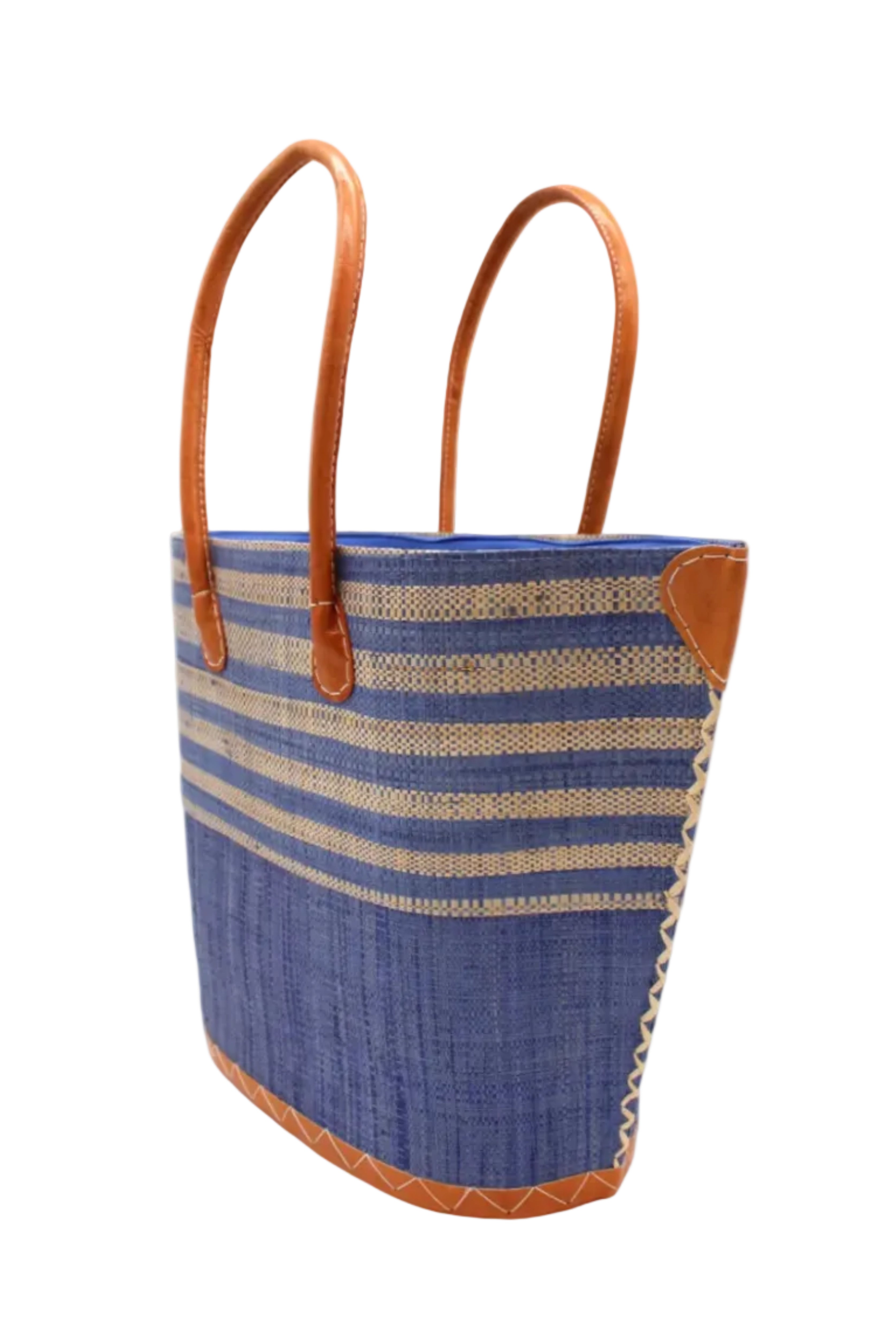 Side view Santa Cruz Denim & Natural Two Tone Wide Stripe Small Straw Tote Bag handmade loomed natural raffia palm fiber in a two tone color block pattern of solid denim retro/light/blue on the bottom half of the bag and two tone even width horizontal stripes of denim and natural straw color on the top half of the bag with leather handles and details beach bag handbag purse - Shebobo