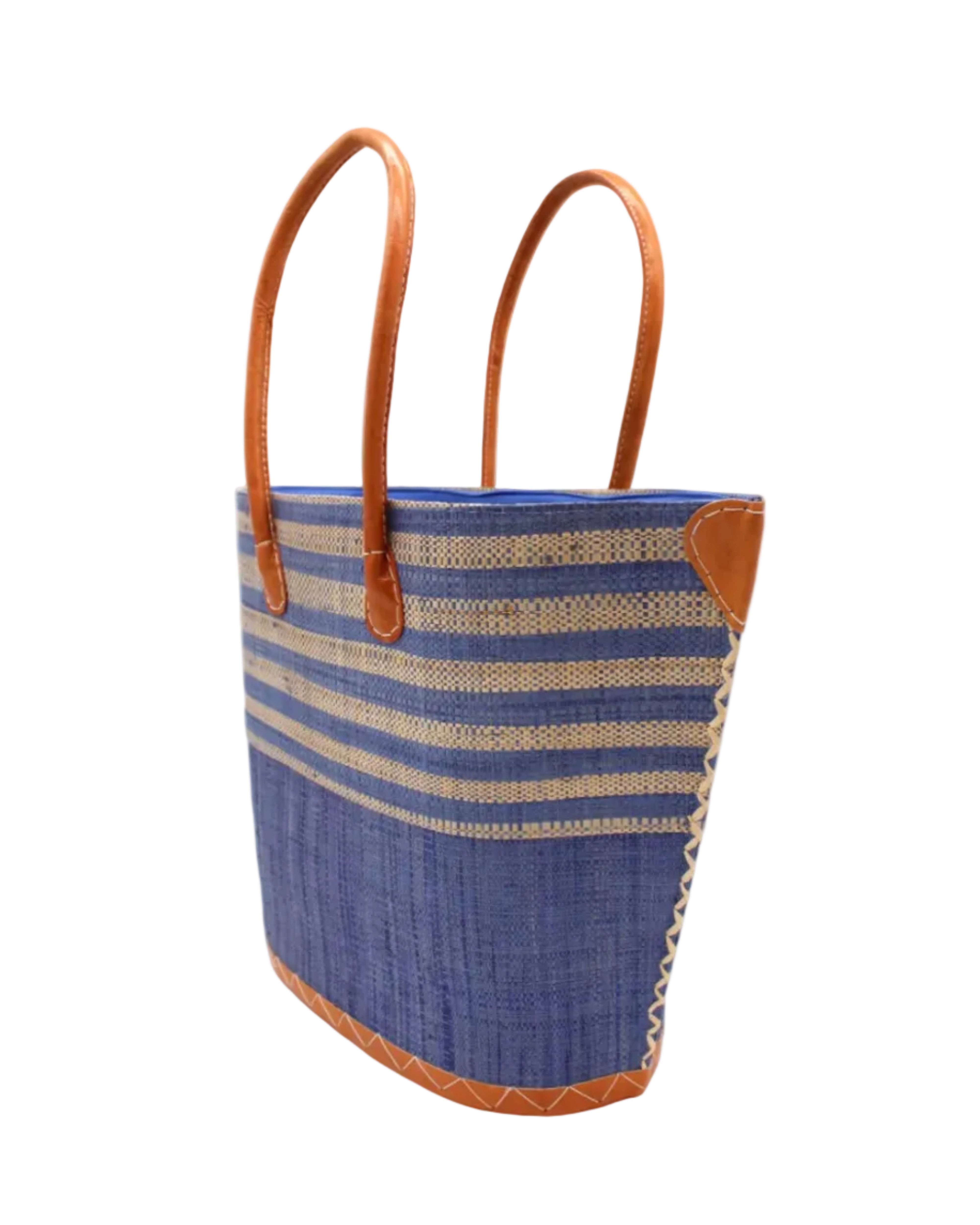 Side view Santa Cruz Denim & Natural Two Tone Wide Stripe Small Straw Tote Bag handmade loomed natural raffia palm fiber in a two tone color block pattern of solid denim retro/light/blue on the bottom half of the bag and two tone even width horizontal stripes of denim and natural straw color on the top half of the bag with leather handles and details beach bag handbag purse - Shebobo