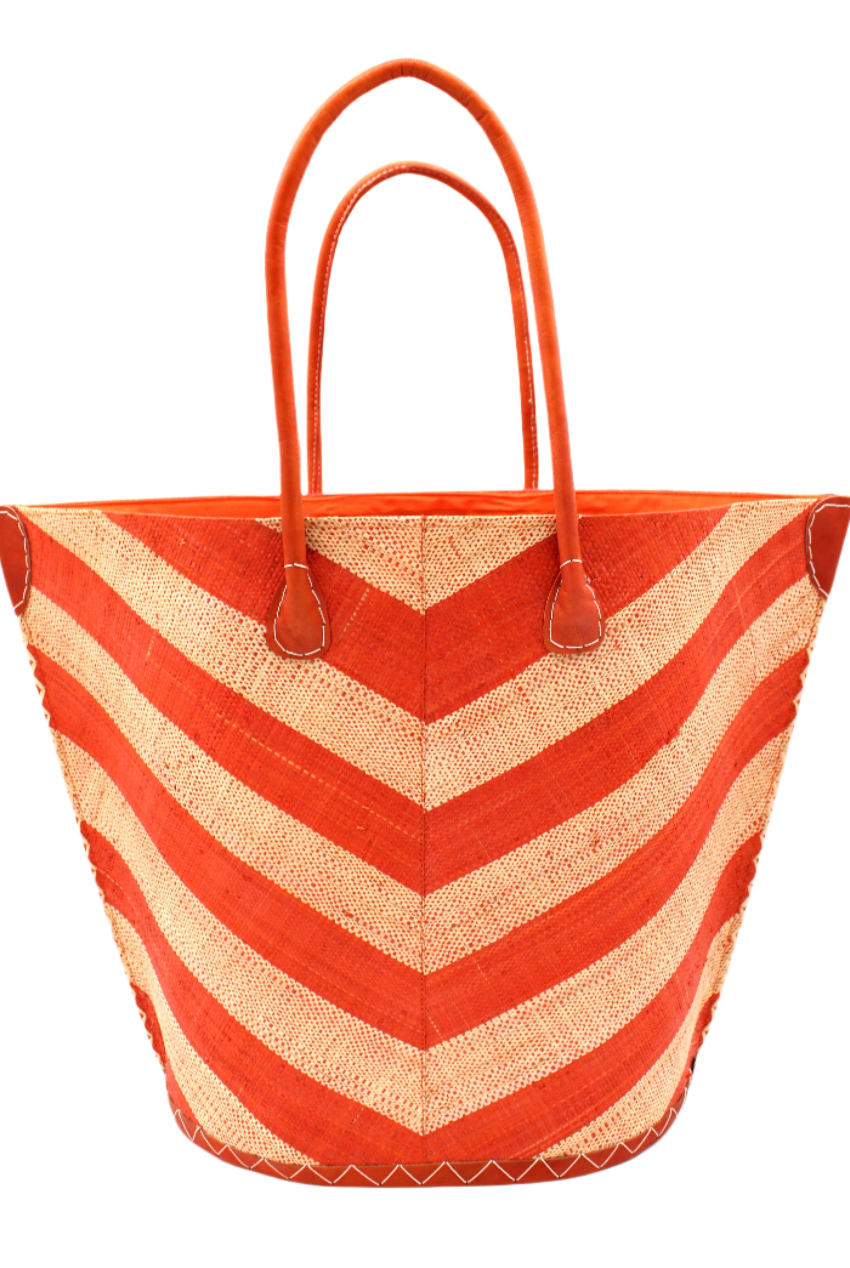 Santa Cruz Wide Stripe Chevron Large Straw Tote Bag handmade loomed raffia palm fiber in a two tone diagonal even width bands of color in a wide stripe chevron pattern of coral orange/red and natural straw color on the front and a matching solid hue on the back with leather accents and handles large shoulder bag - Shebobo
