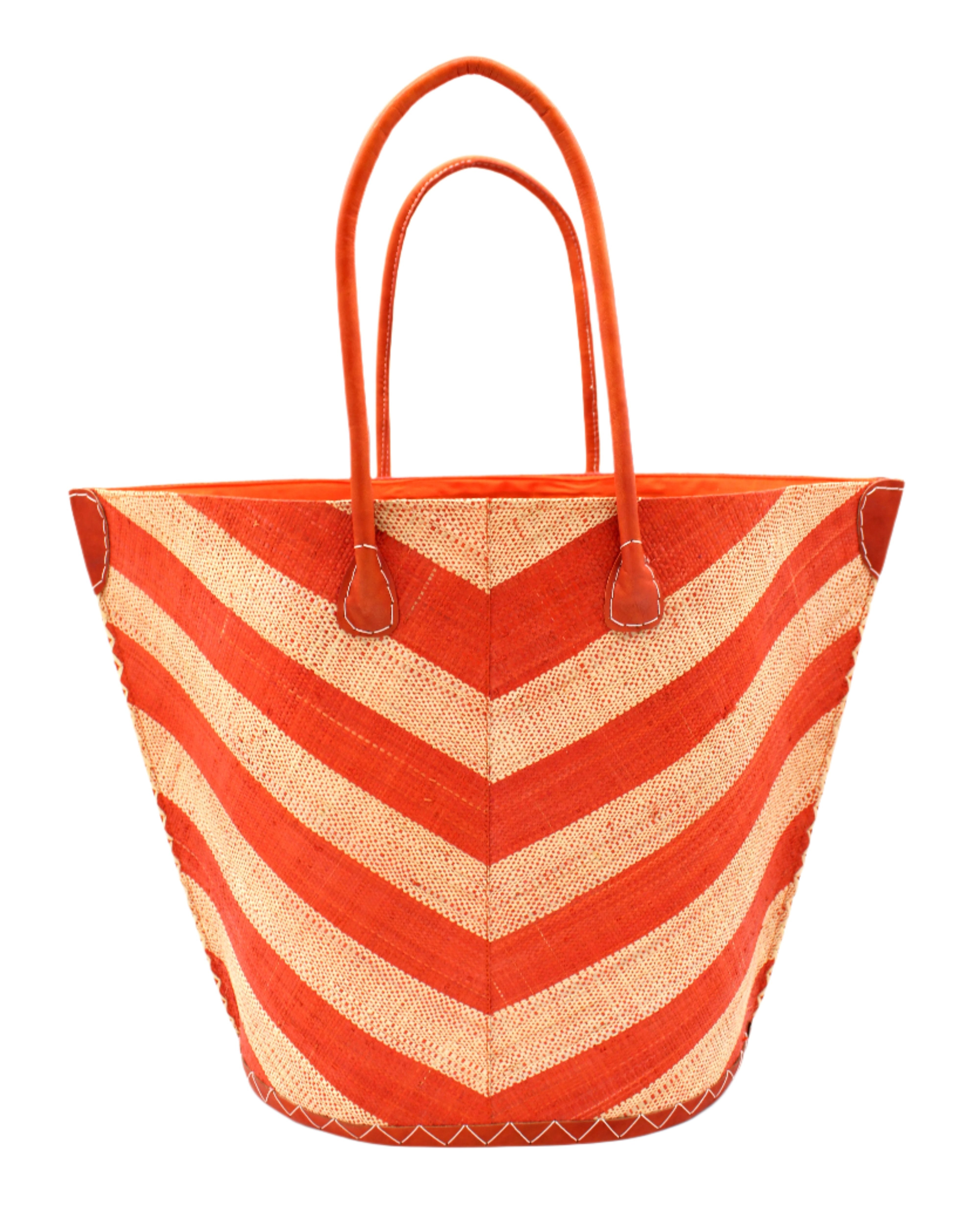 Santa Cruz Wide Stripe Chevron Large Straw Tote Bag handmade loomed raffia palm fiber in a two tone diagonal even width bands of color in a wide stripe chevron pattern of coral orange/red and natural straw color on the front and a matching solid hue on the back with leather accents and handles large shoulder bag - Shebobo