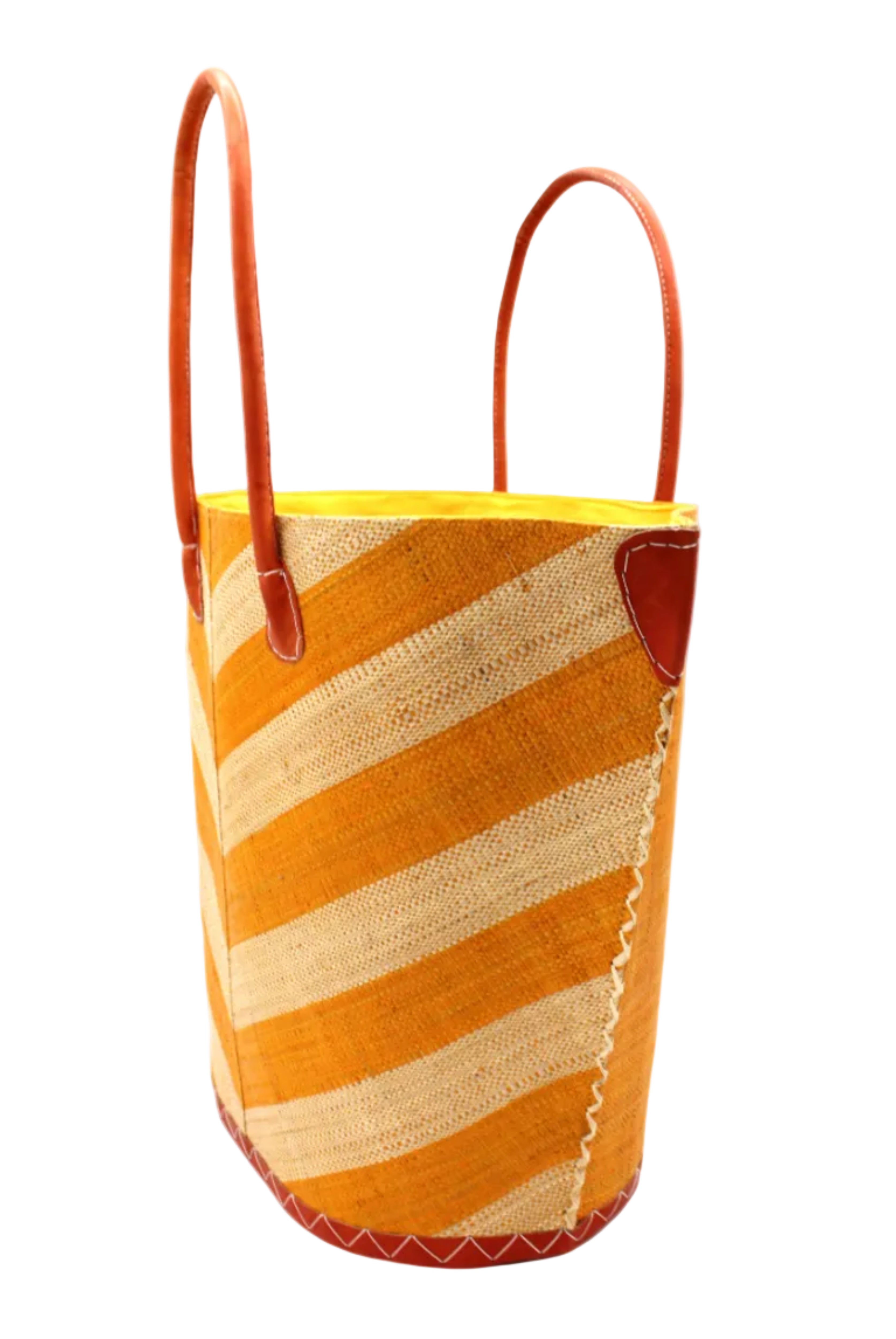 Side view Santa Cruz Wide Stripe Chevron Large Straw Tote Bag handmade loomed raffia palm fiber in a two tone diagonal even width bands of color in a wide stripe chevron pattern of saffron yellow/orange and natural straw color on the front and a matching solid hue on the back with leather accents and handles large shoulder bag - Shebobo