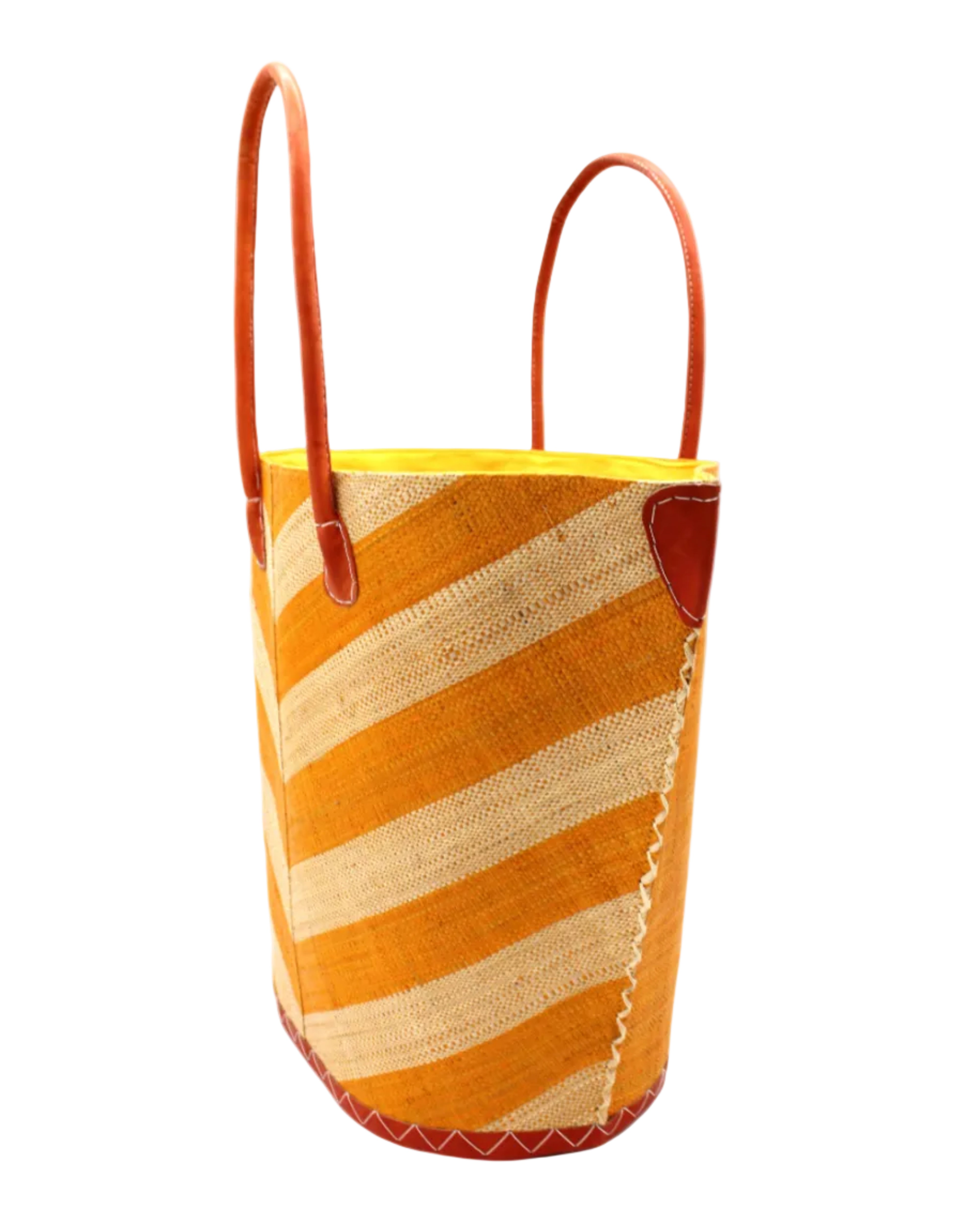 Side view Santa Cruz Wide Stripe Chevron Large Straw Tote Bag handmade loomed raffia palm fiber in a two tone diagonal even width bands of color in a wide stripe chevron pattern of saffron yellow/orange and natural straw color on the front and a matching solid hue on the back with leather accents and handles large shoulder bag - Shebobo