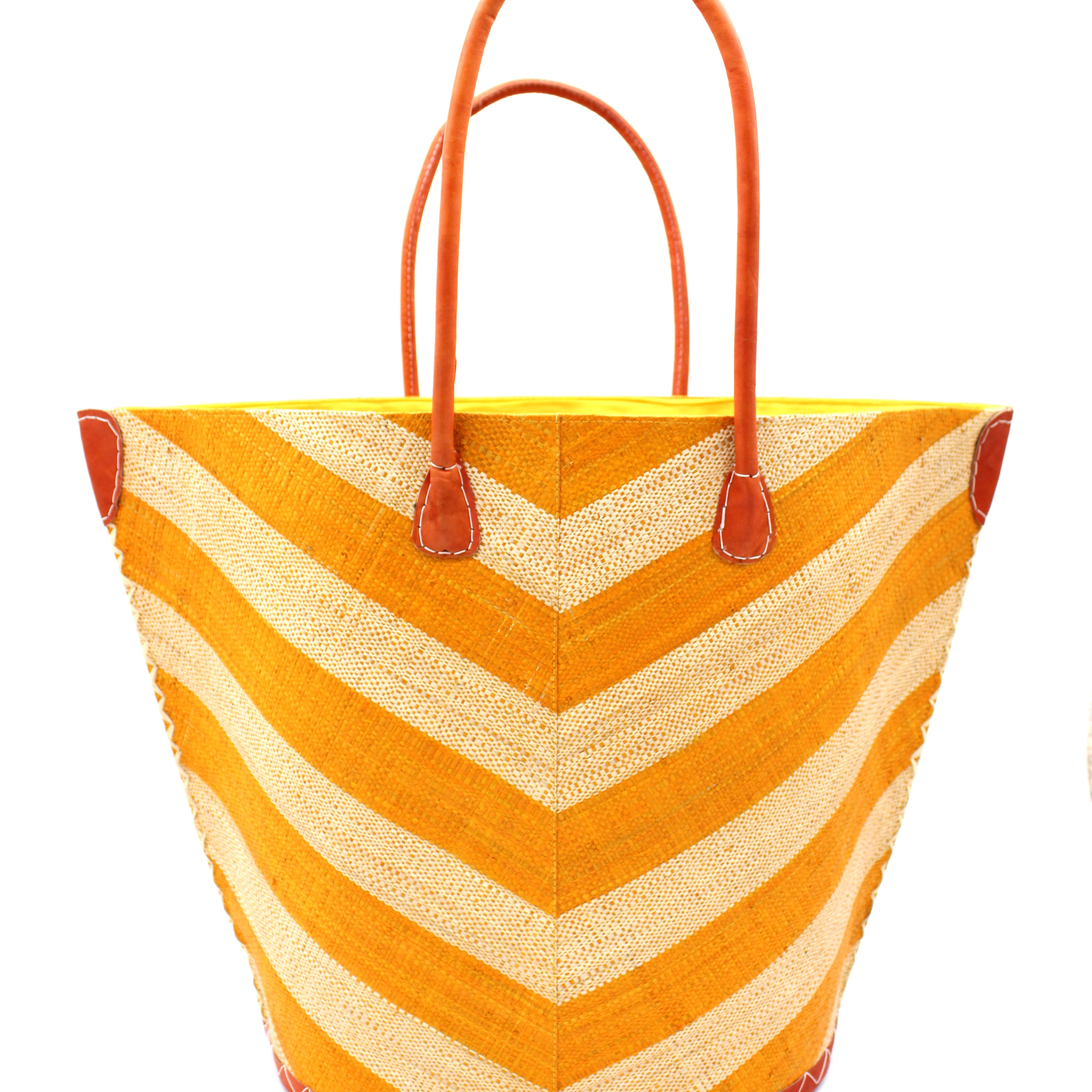Santa Cruz Wide Stripe Chevron Large Straw Tote Bag handmade loomed raffia palm fiber in a two tone diagonal even width bands of color in a wide stripe chevron pattern of saffron orange/yellow and natural straw color on the front and a matching solid hue on the back with leather accents and handles large shoulder bag - Shebobo
