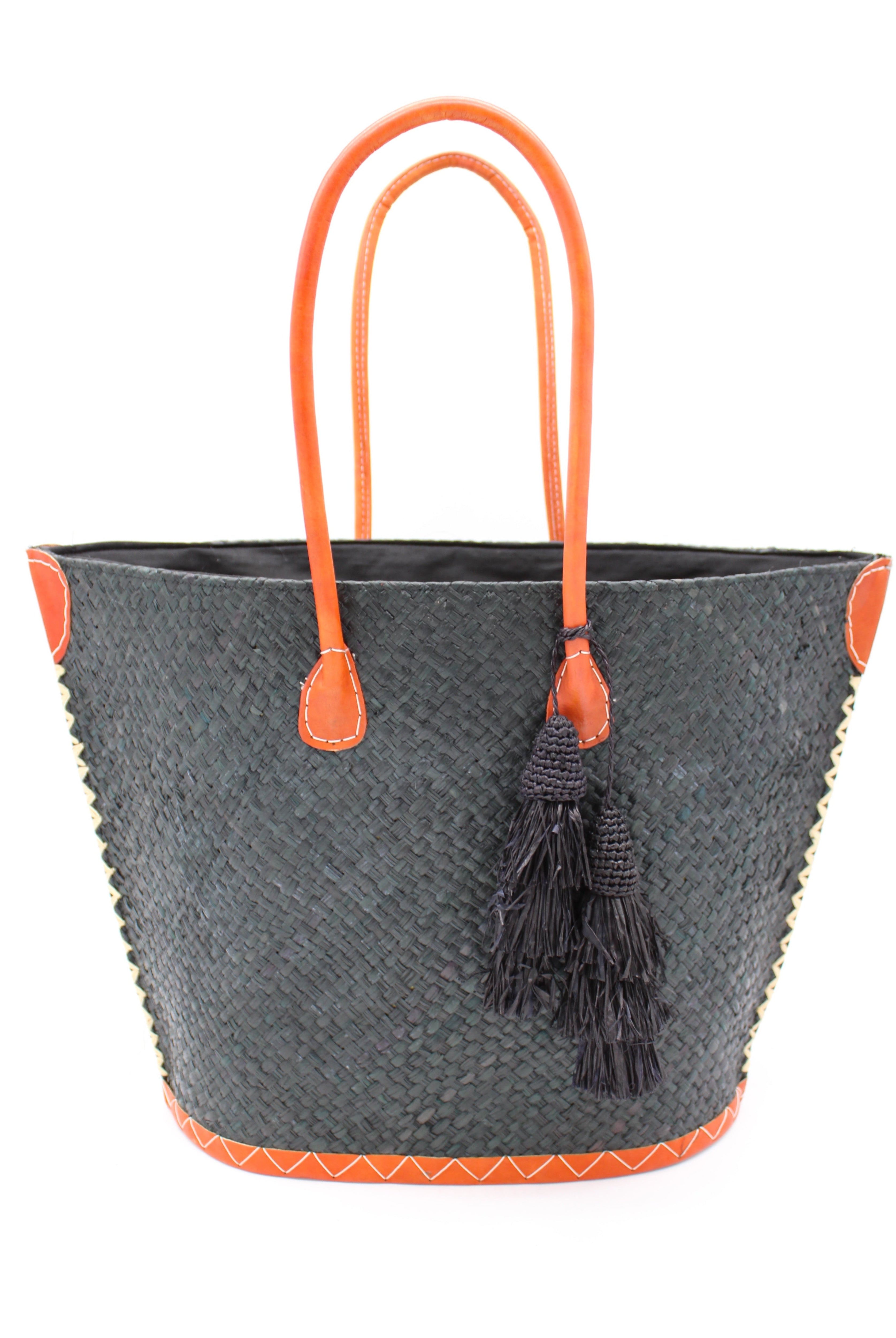 Santa Ynez Woven Small Straw Tote Bag with Tassel Charm Embellishment handmade woven raffia palm fiber in a solid hue of black with matching tassel tie charm embellishment and leather handles beach bag - Shebobo