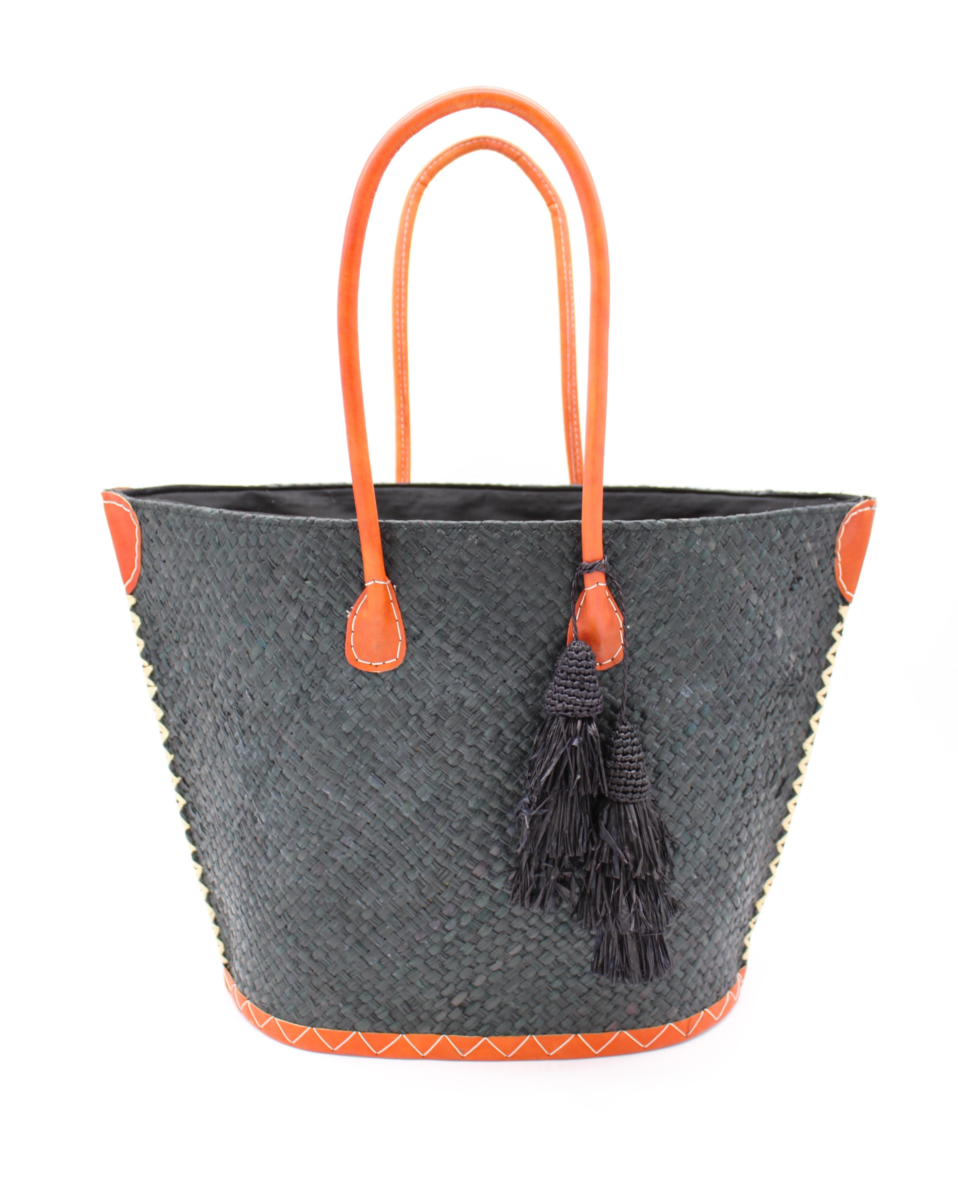 Santa Ynez Woven Small Straw Tote Bag with Tassel Charm Embellishment handmade woven raffia palm fiber in a solid hue of black with matching tassel tie charm embellishment and leather handles beach bag - Shebobo