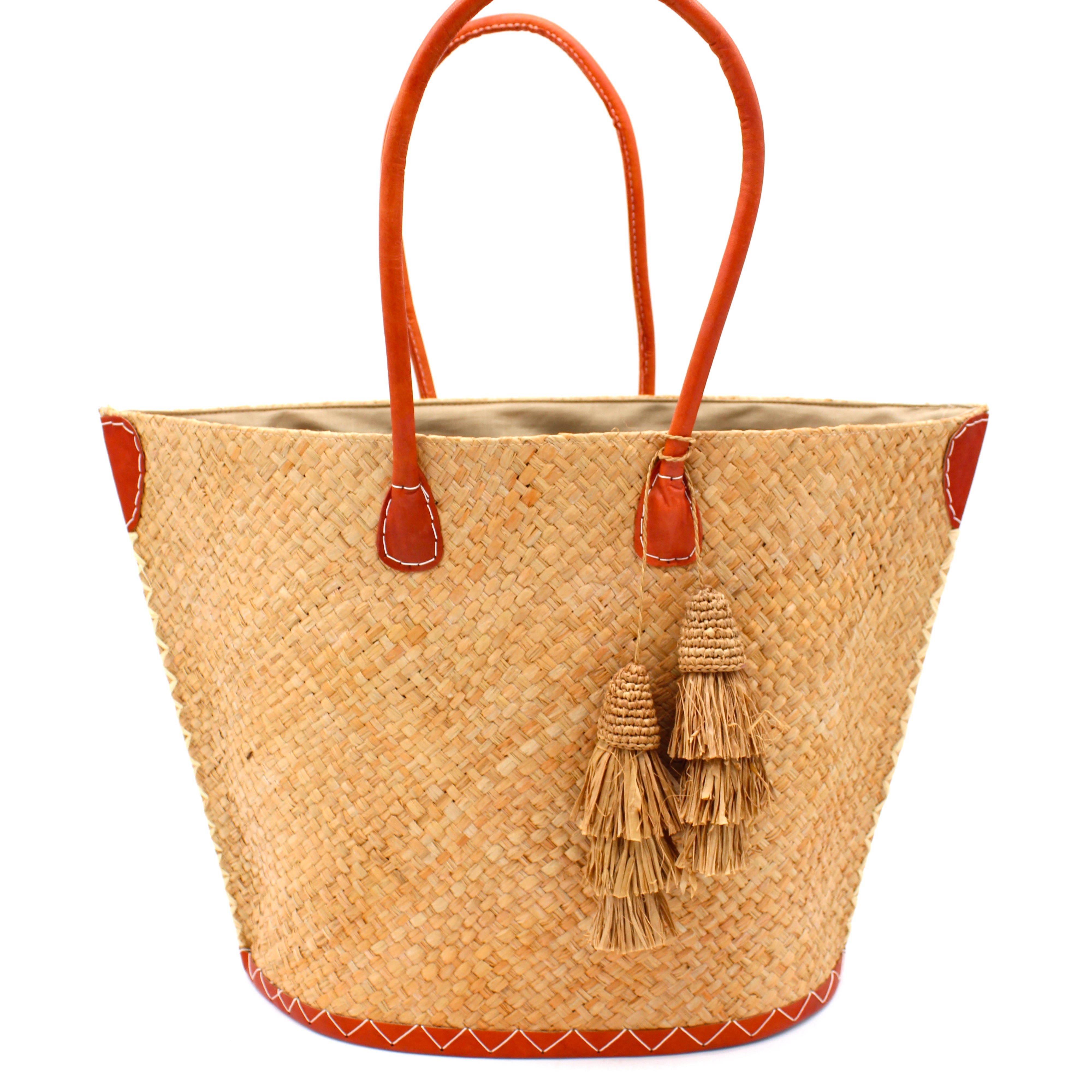 Santa Ynez Cappuccino Woven Small Straw Tote Bag with Tassel Charm Embellishment handmade woven raffia palm fiber in a solid hue of cappuccino tea/light/brown creating a subtle wide cross weave texture with matching crochet topped multi tuft tassel embellishment and leather handles shoulder bag beach bag - Shebobo