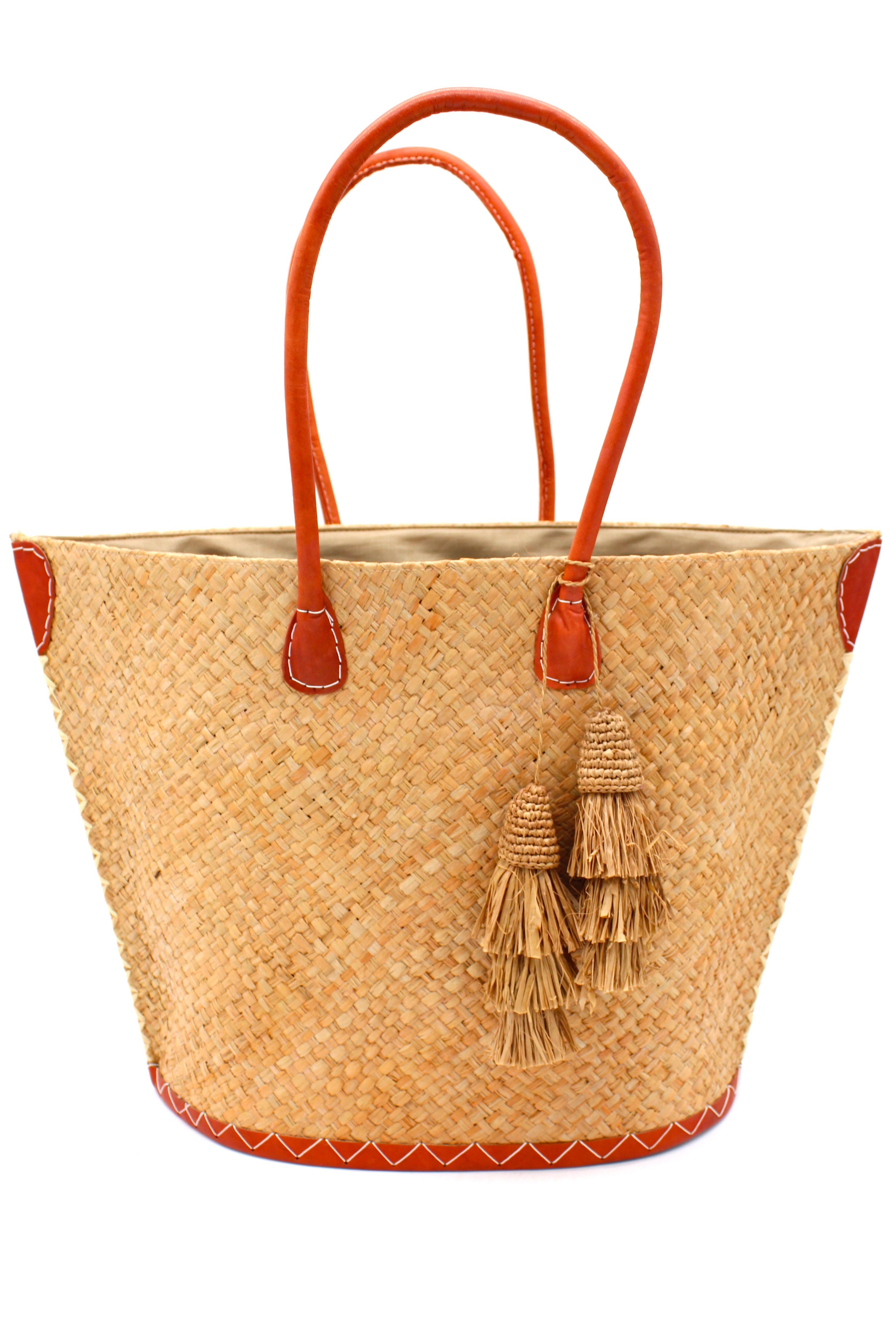 Santa Ynez Cappuccino Woven Small Straw Tote Bag with Tassel Charm Embellishment handmade woven raffia palm fiber in a solid hue of cappuccino tea/light/brown creating a subtle wide cross weave texture with matching crochet topped multi tuft tassel embellishment and leather handles shoulder bag beach bag - Shebobo