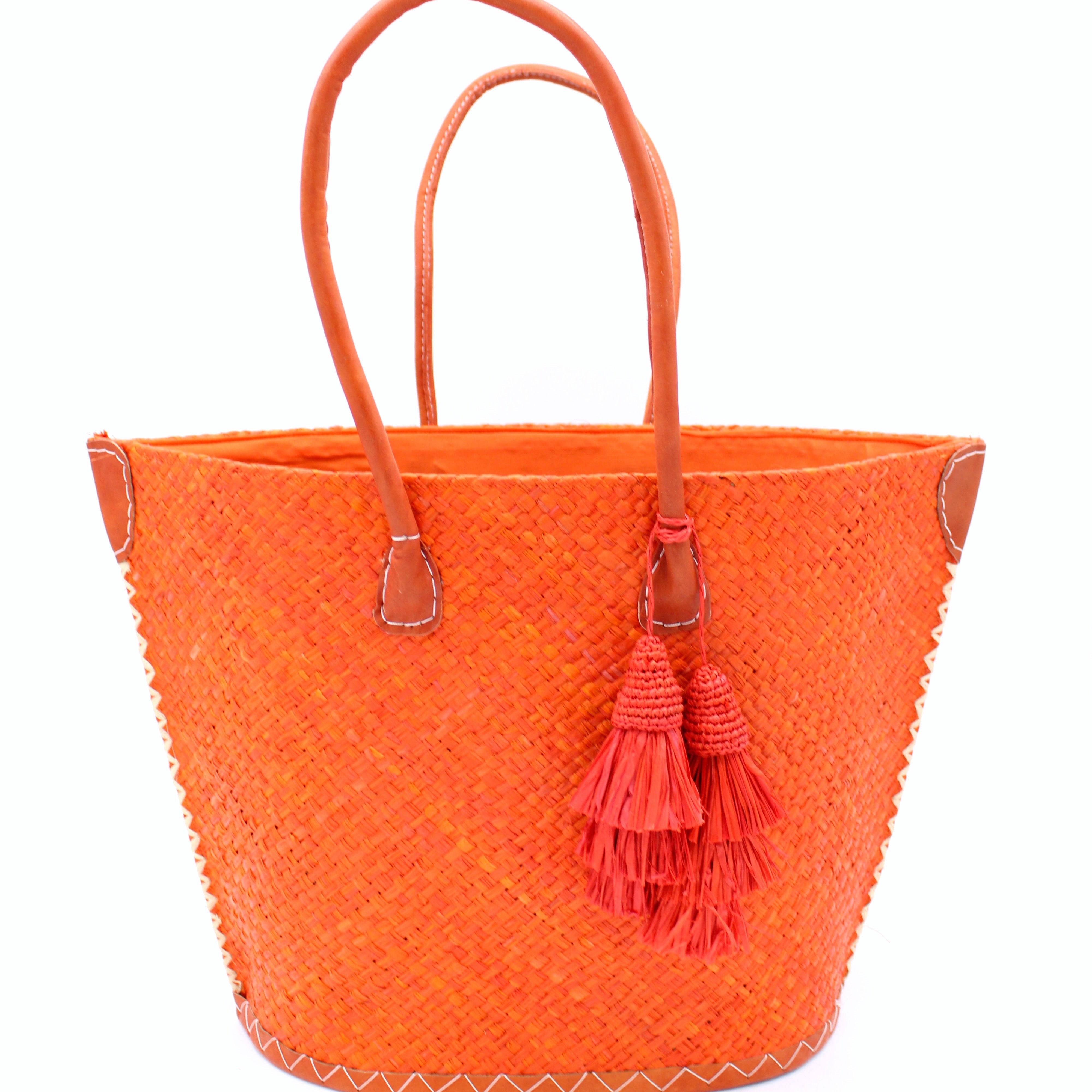 Santa Ynez Woven Small Straw Tote Bag with Tassel Charm Embellishment handmade woven raffia palm fiber in a solid hue of coral orange/red with matching tassel tie charm embellishment and leather handles beach bag - Shebobo