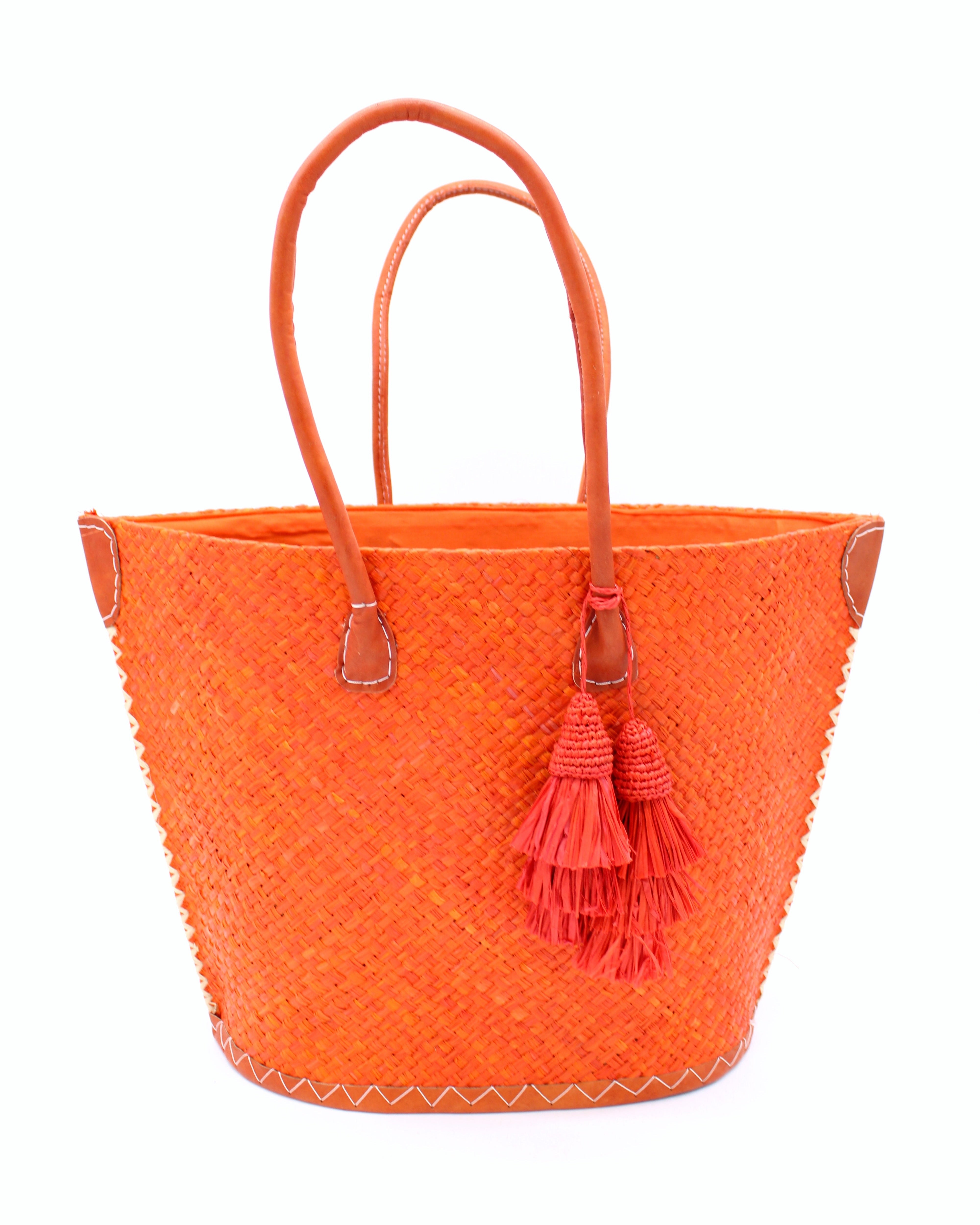 Santa Ynez Woven Small Straw Tote Bag with Tassel Charm Embellishment handmade woven raffia palm fiber in a solid hue of coral orange/red with matching tassel tie charm embellishment and leather handles beach bag - Shebobo