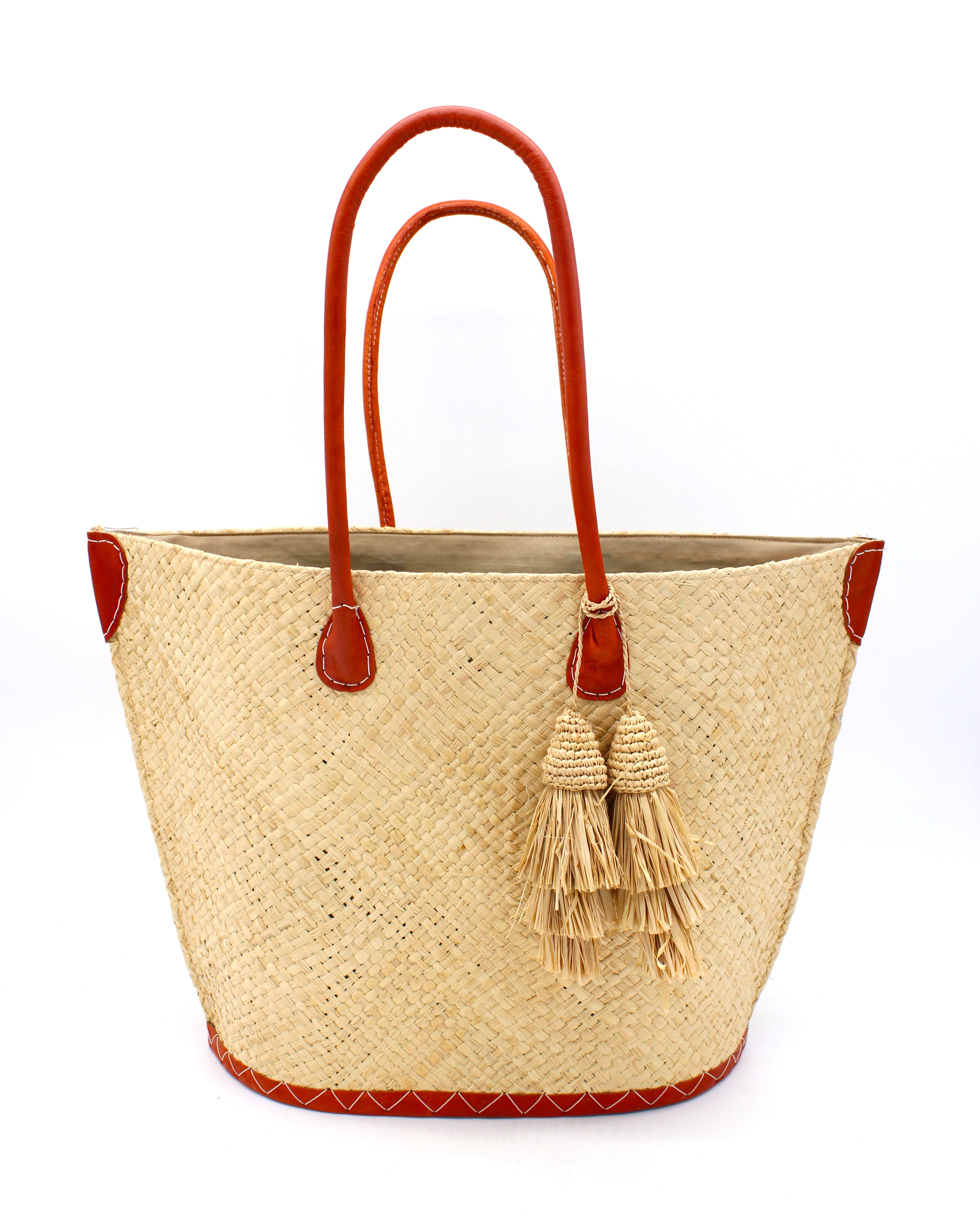 Santa Ynez Woven Small Straw Tote Bag with Tassel Charm Embellishment handmade woven raffia palm fiber in a solid hue of natural straw color with matching tassel tie charm embellishment and leather handles beach bag - Shebobo