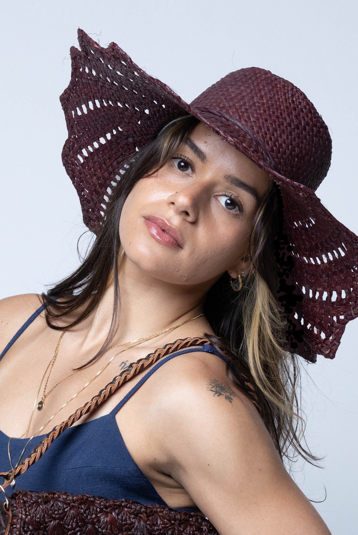 Model wearing Sara 4.5" Brim Woven Straw Sun Hats with Zigzag Edge handmade natural raffia palm fiber in a solid hue of espresso chocolate/dark/brown woven with a subtle crosshatch texture across the crown and spiraling open weave across the brim with matching hat band and zigzag edge - Shebobo