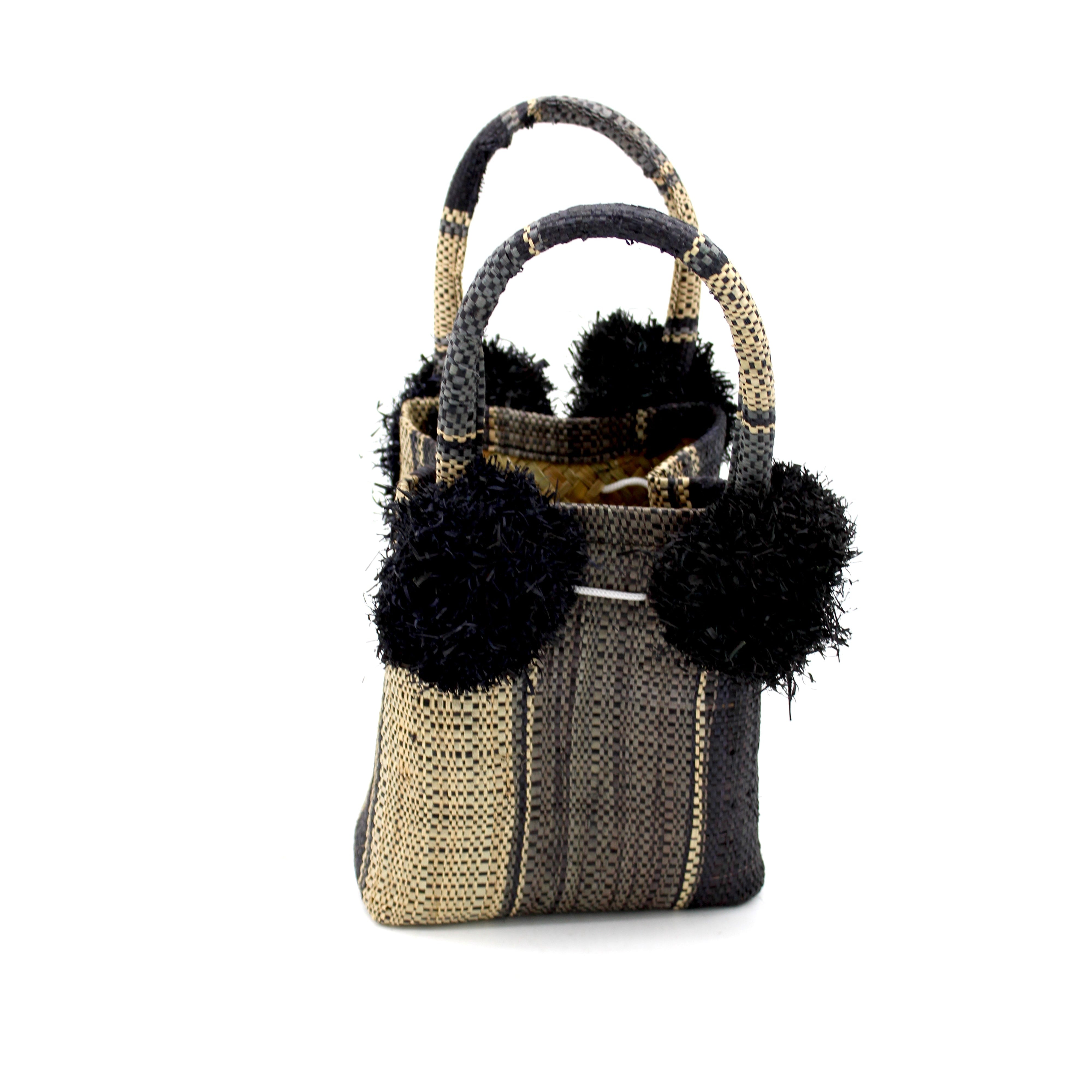 Schooner Black Swirl Straw Mini Bag with Pompom Accent handmade loomed natural raffia palm fiber in multi width vertical multicolor stripe pattern of black, grey, and natural straw color with four matching raffia pompom embellishments at the base of each handle attachment tiny purse extra small handbag - Shebobo