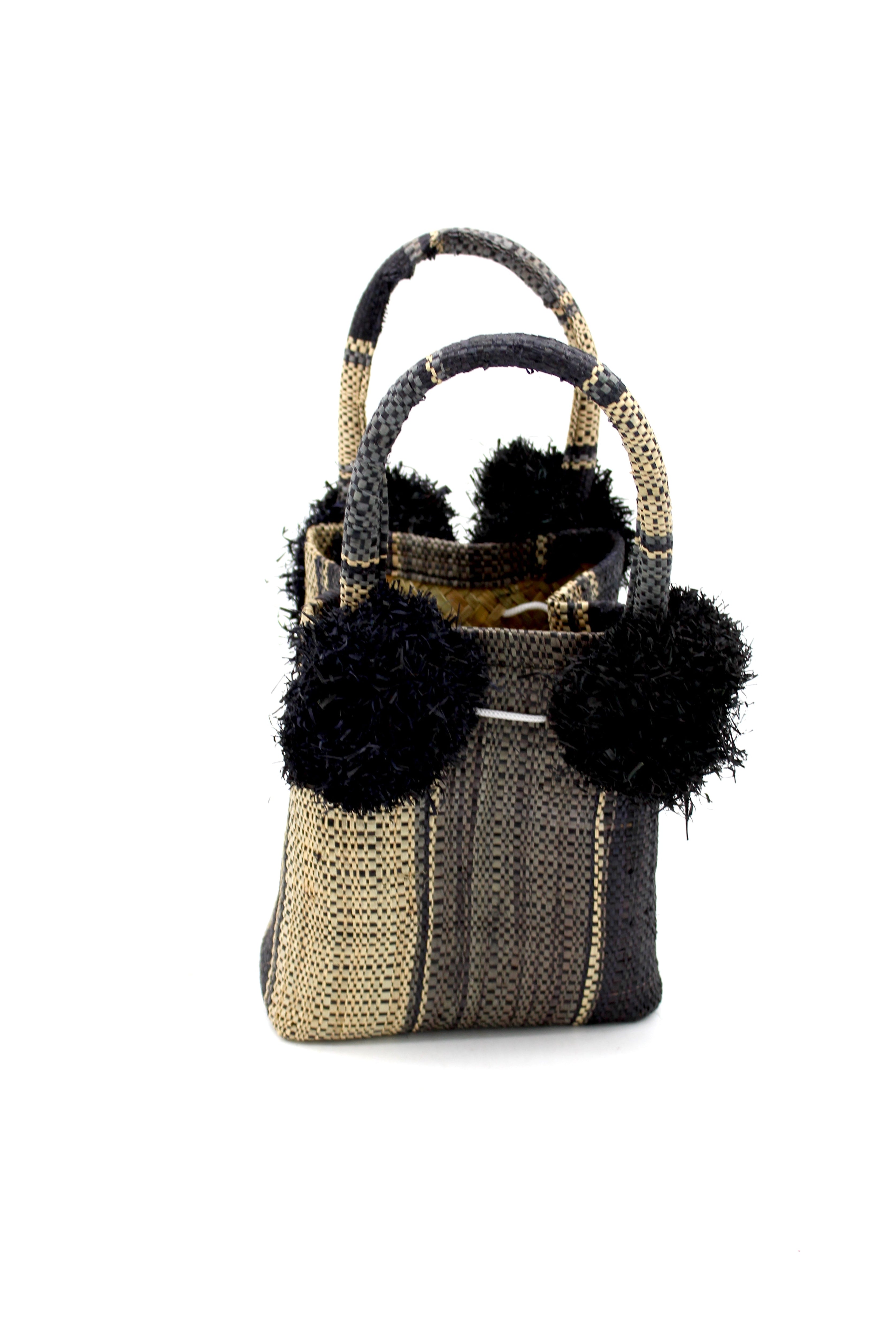 Schooner Black Swirl Straw Mini Bag with Pompom Accent handmade loomed natural raffia palm fiber in multi width vertical multicolor stripe pattern of black, grey, and natural straw color with four matching raffia pompom embellishments at the base of each handle attachment tiny purse extra small handbag - Shebobo