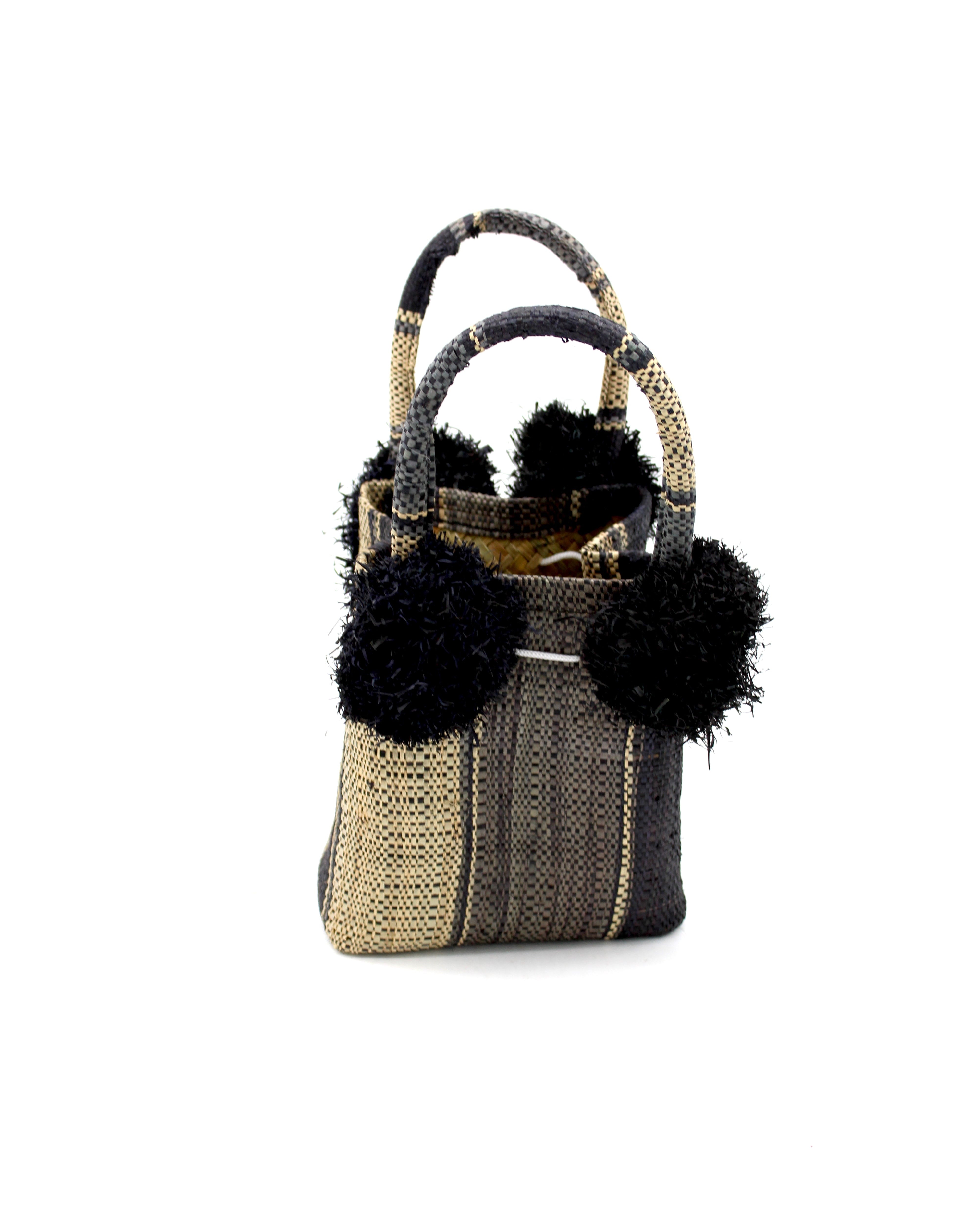 Schooner Black Swirl Straw Mini Bag with Pompom Accent handmade loomed natural raffia palm fiber in multi width vertical multicolor stripe pattern of black, grey, and natural straw color with four matching raffia pompom embellishments at the base of each handle attachment tiny purse extra small handbag - Shebobo