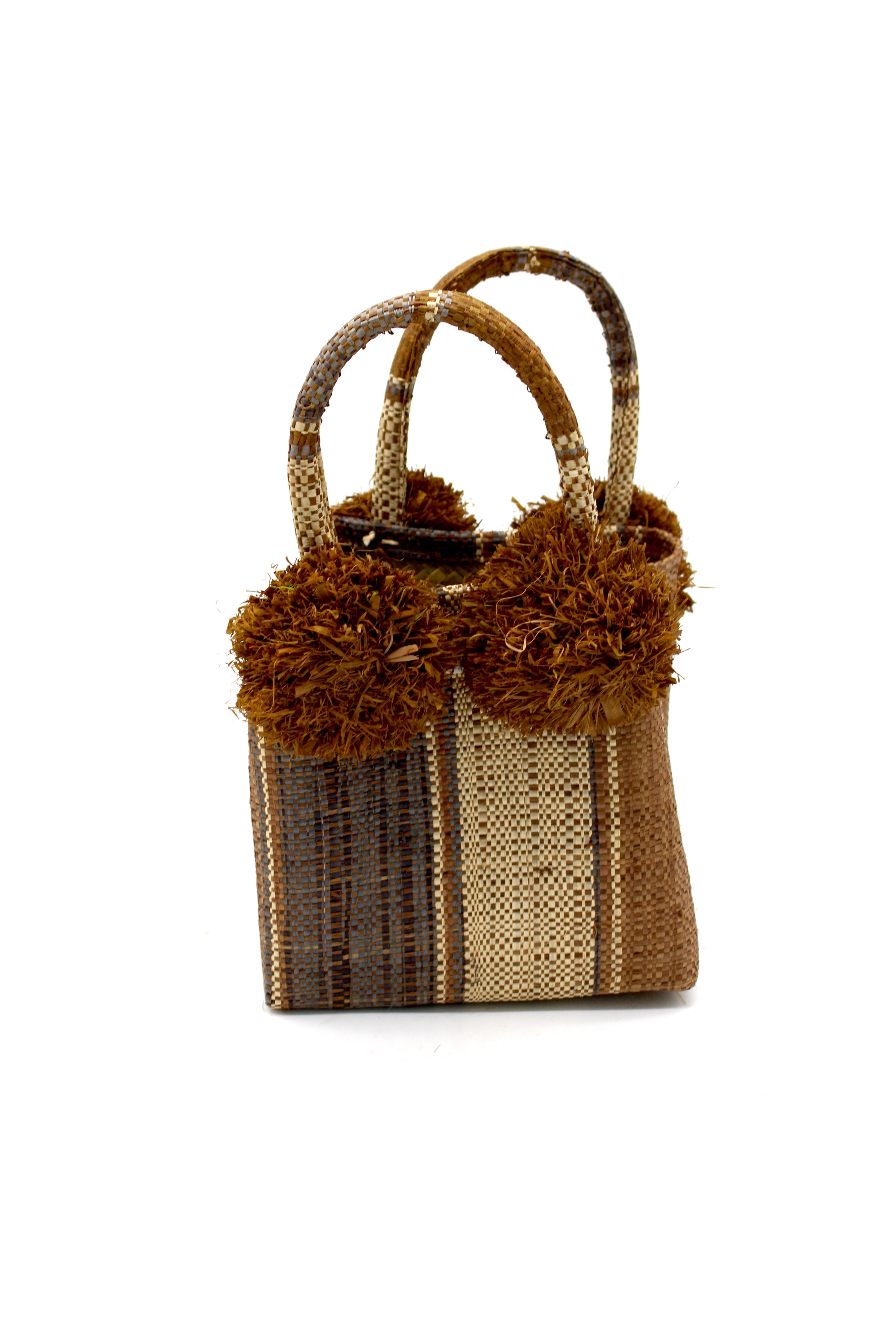 Schooner Cinnamon Swirl Straw Mini Bag with Pompom Accent handmade loomed natural raffia palm fiber in multi width vertical multicolor stripe pattern of cinnamon/tobacco/brown, grey, and natural straw color with four matching raffia pompom embellishments at the base of each handle attachment tiny purse extra small handbag - Shebobo