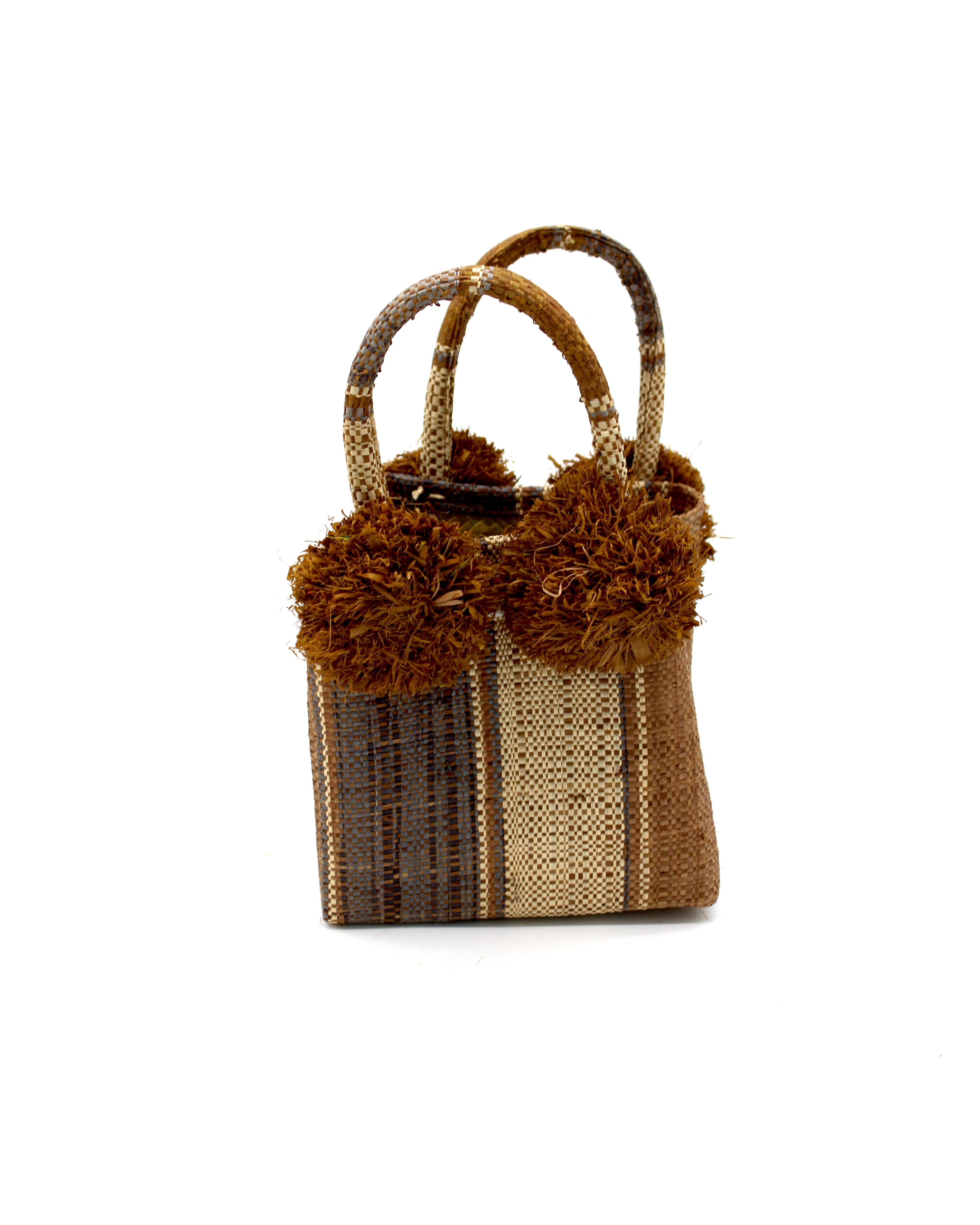 Schooner Cinnamon Swirl Straw Mini Bag with Pompom Accent handmade loomed natural raffia palm fiber in multi width vertical multicolor stripe pattern of cinnamon/tobacco/brown, grey, and natural straw color with four matching raffia pompom embellishments at the base of each handle attachment tiny purse extra small handbag - Shebobo
