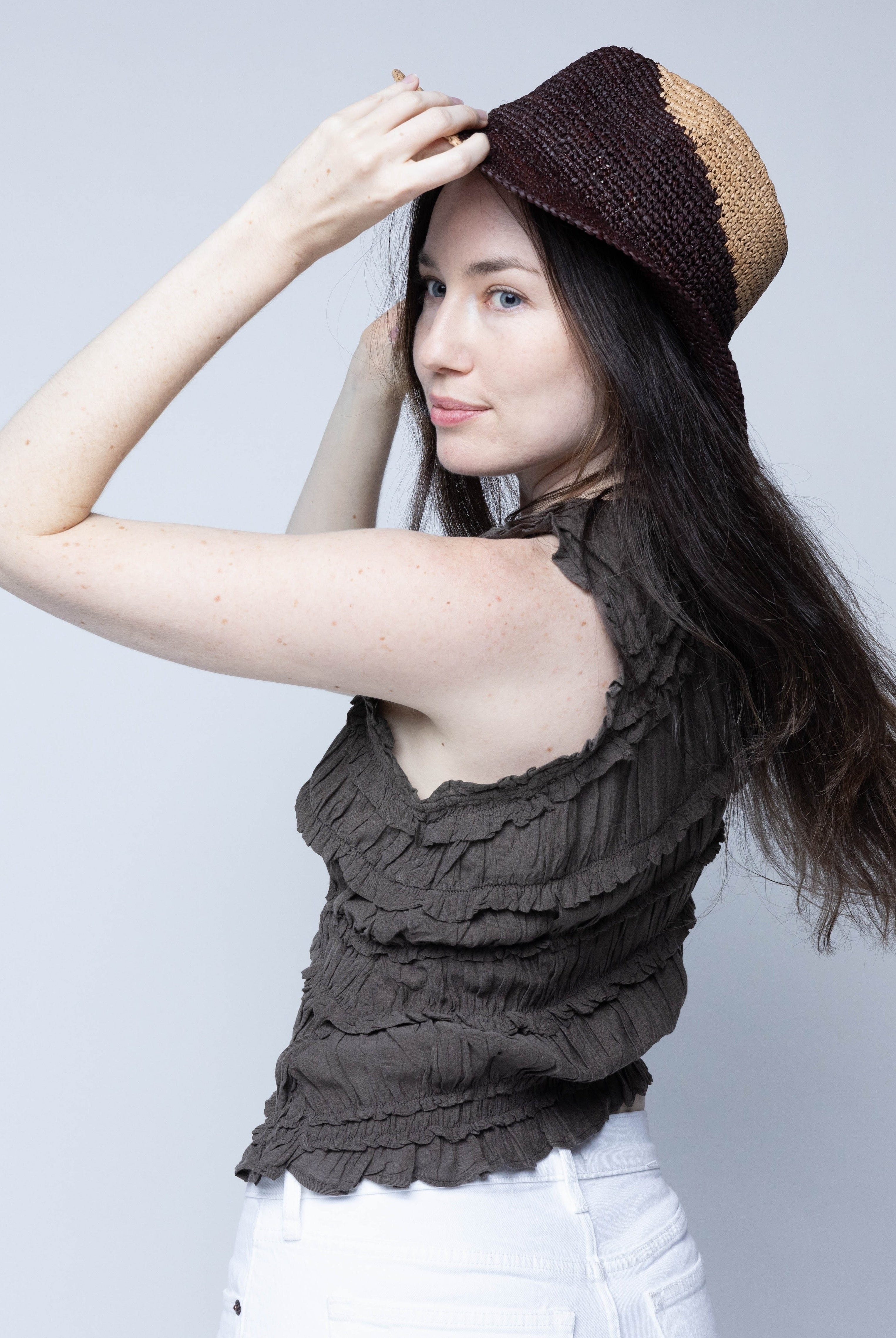 Model wearing Sequoia Cappuccino & Mocha 3" Brim Swirl Crochet Panama Unisex Straw Hats handmade crochet natural raffia palm fiber in a two tone color swirl design of cappuccino tea/light/brown and mocha dark/chocolate/brown spiraling together from wide bands around the brim to a narrow twist at the top of the crown - Shebobo