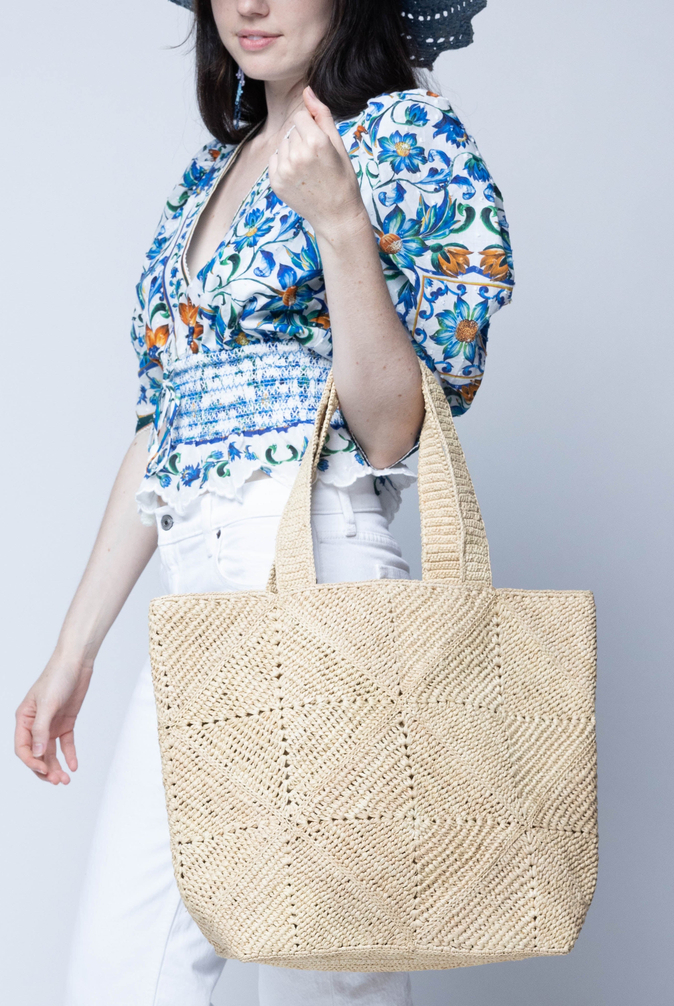 Model wearing Seychelle Natural Diamond Pattern Crochet Straw Basket Handbag handmade natural raffia palm fiber in a solid hue of natural straw color with subtle geometric diamond diagonal pattern with matching crochet handles beach bag tote purse - Shebobo