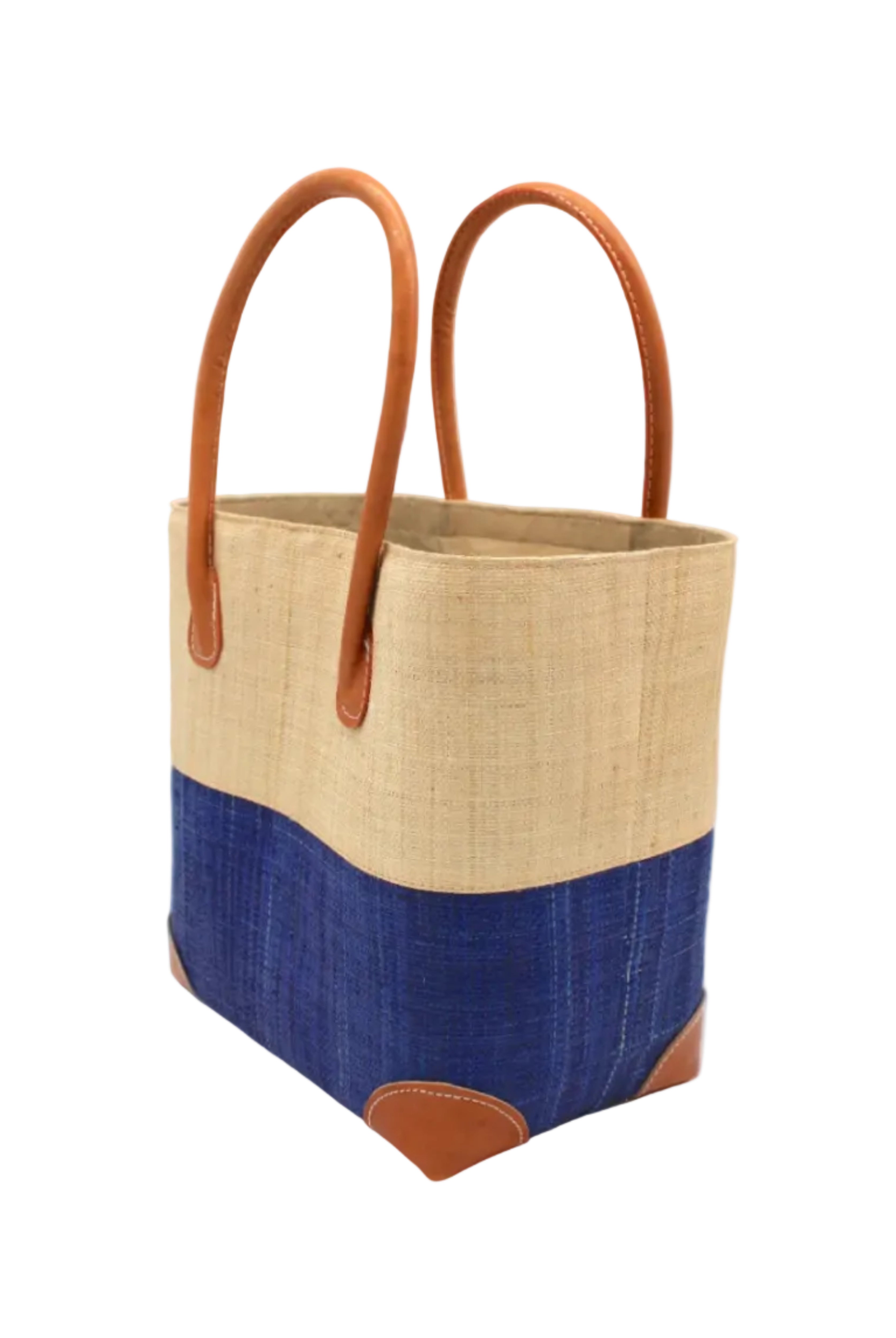 Side view Trinidad Natural and Azure Two Tone Straw Basket Bag handmade loomed raffia palm fiber in a two tone color block pattern with Azure dark/dusk/navy/blue on the bottom half and natural straw color on the top half of the bag with leather handles and accents beach bag tote purse - Shebobo