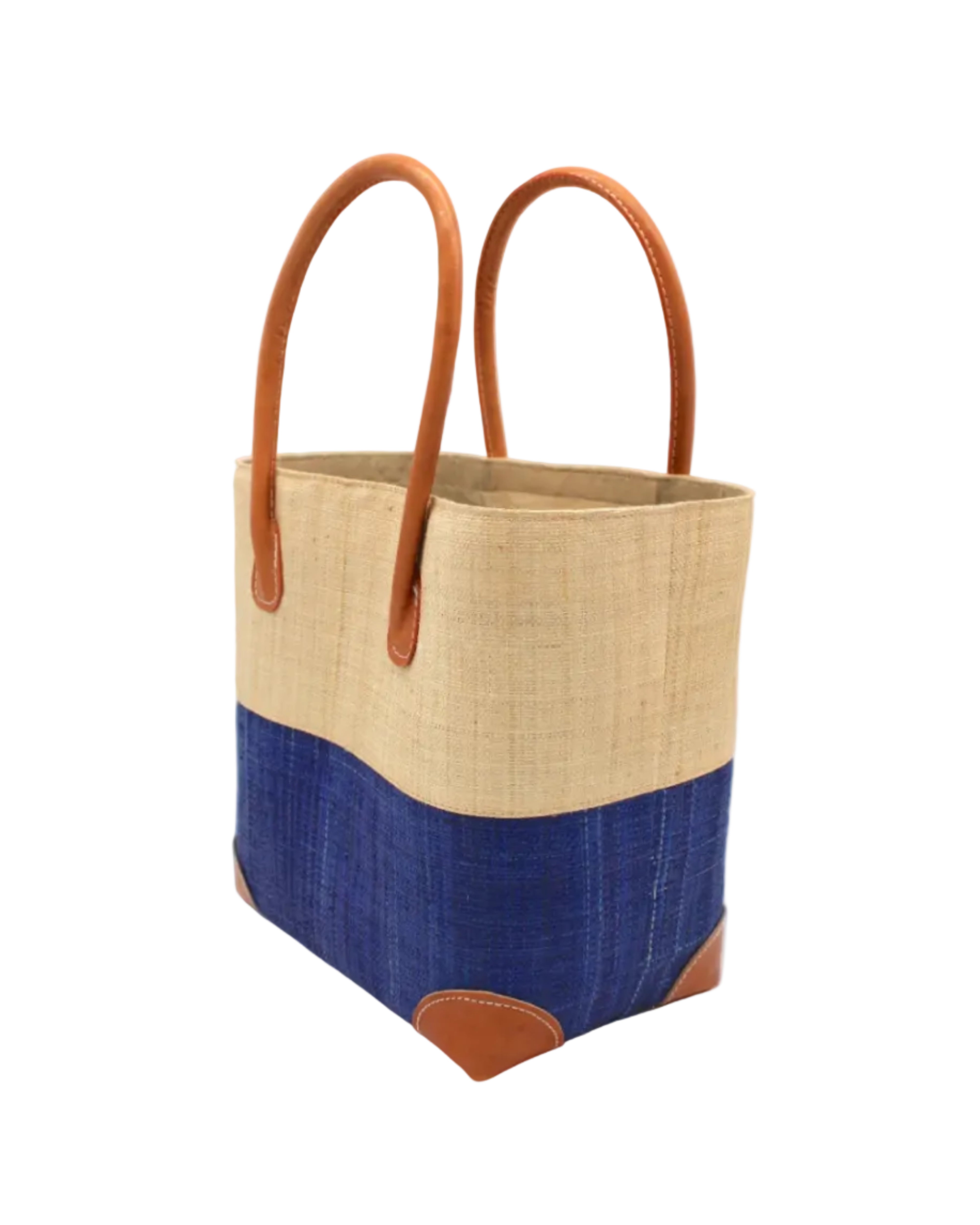 Side view Trinidad Natural and Azure Two Tone Straw Basket Bag handmade loomed raffia palm fiber in a two tone color block pattern with Azure dark/dusk/navy/blue on the bottom half and natural straw color on the top half of the bag with leather handles and accents beach bag tote purse - Shebobo