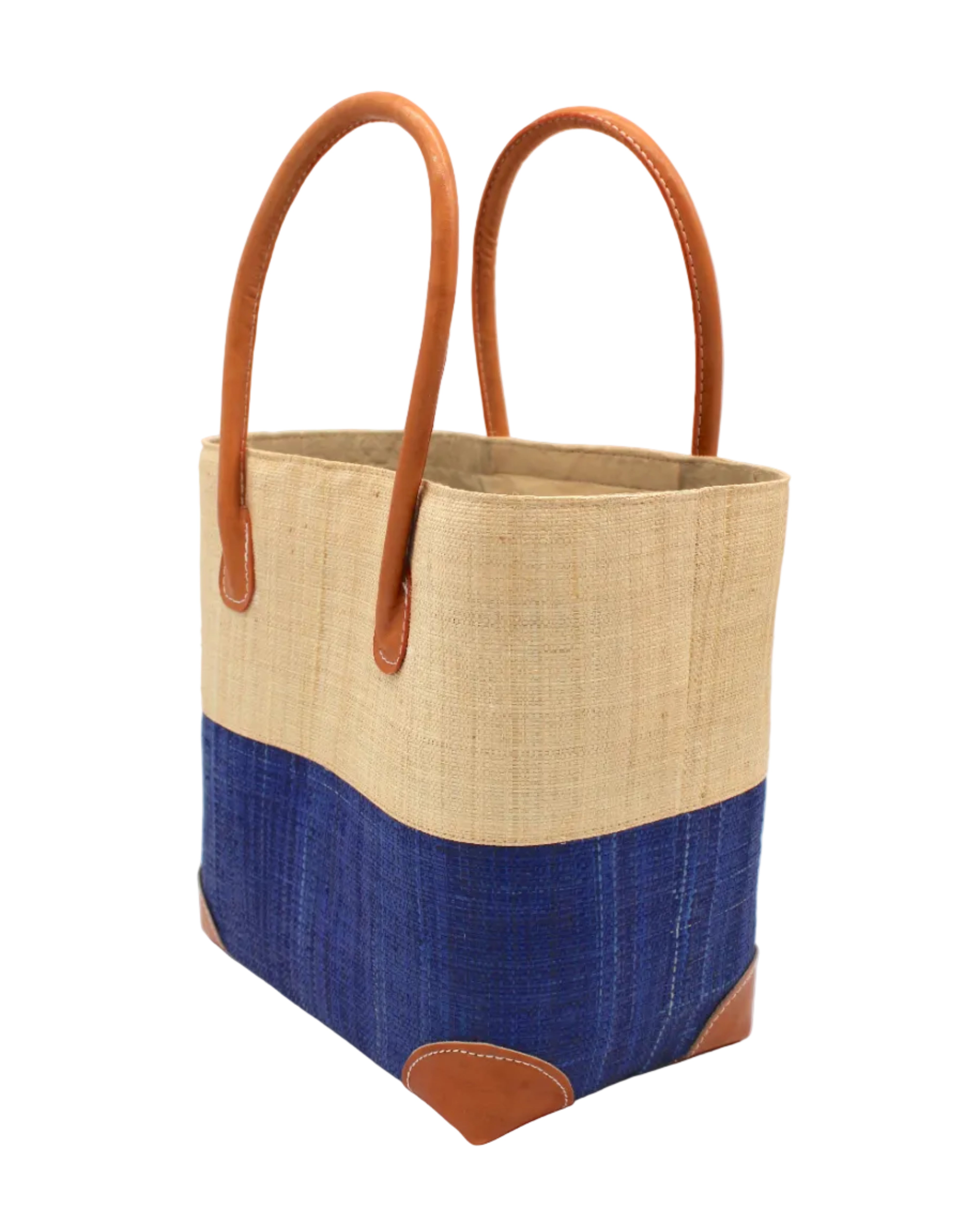 Side view Trinidad Natural and Azure Two Tone Straw Basket Bag handmade loomed raffia palm fiber in a two tone color block pattern with Azure dark/dusk/navy/blue on the bottom half and natural straw color on the top half of the bag with leather handles and accents beach bag tote purse - Shebobo