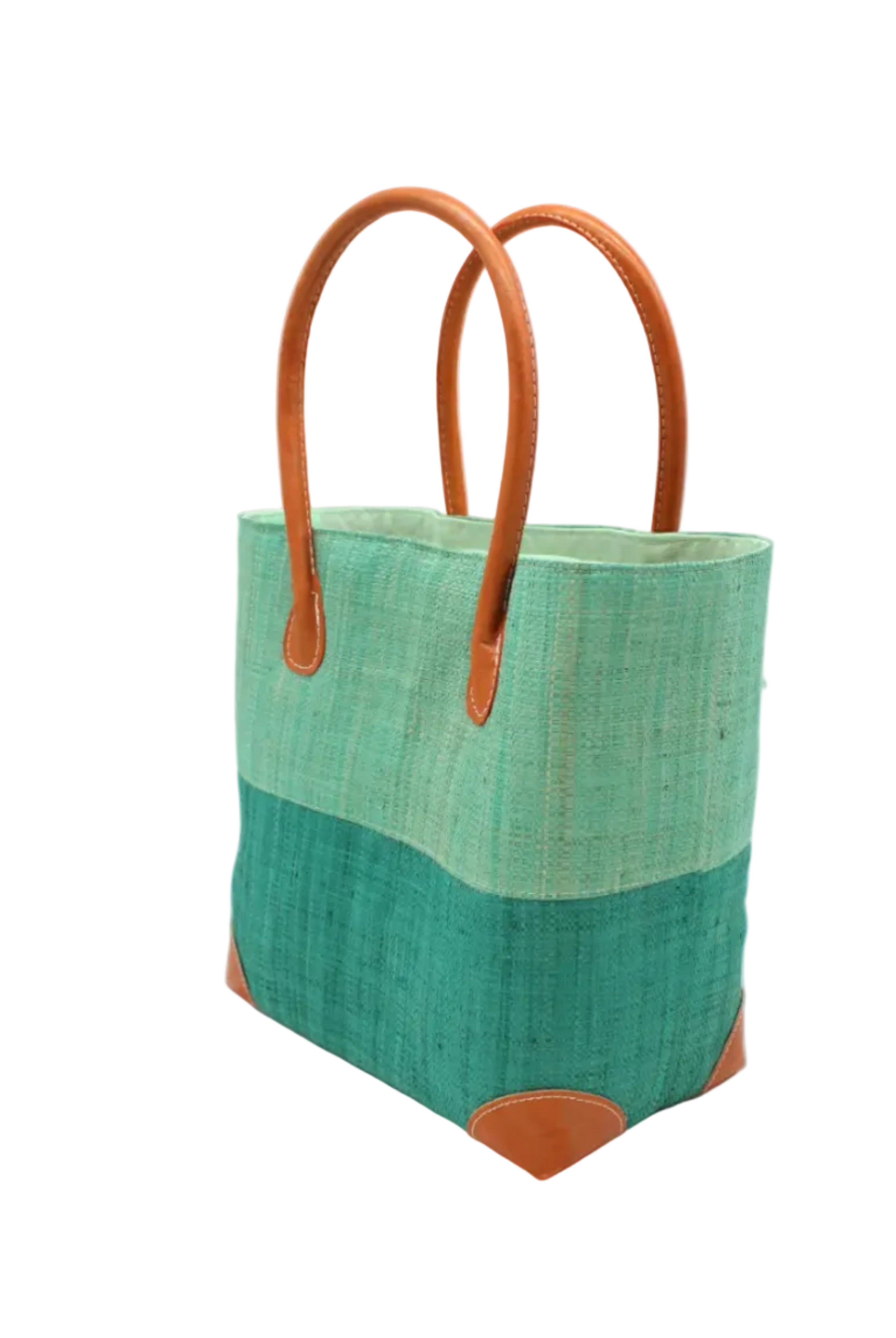 Side view Trinidad Seafoam and Teal Two Tone Straw Basket Bag handmade loomed raffia palm fiber in a two tone color block pattern with teal dark/blue/green on the bottom half and seafoam light/blue/green on the top half of the bag with leather handles and accents beach bag tote purse - Shebobo