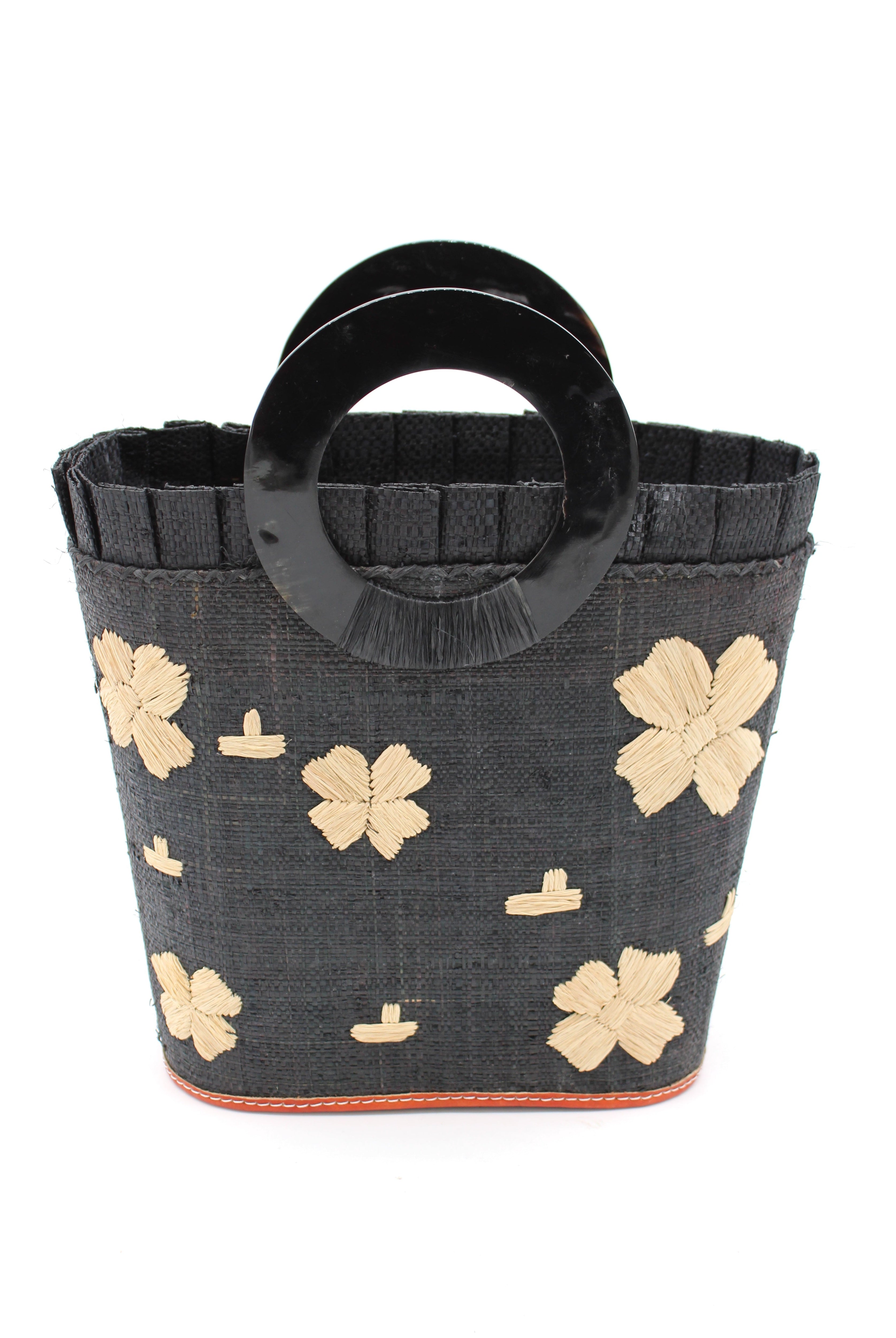 Tulum Straw Bucket Bag with Flower Embroidery and Horn Handle Black Purse with Ruffle Edge handmade loomed raffia palm fiber in a solid hue of black with natural straw color hand embroidered floral pattern with multiple sized flowers and raffia ruffle on the opening handbag - Shebobo