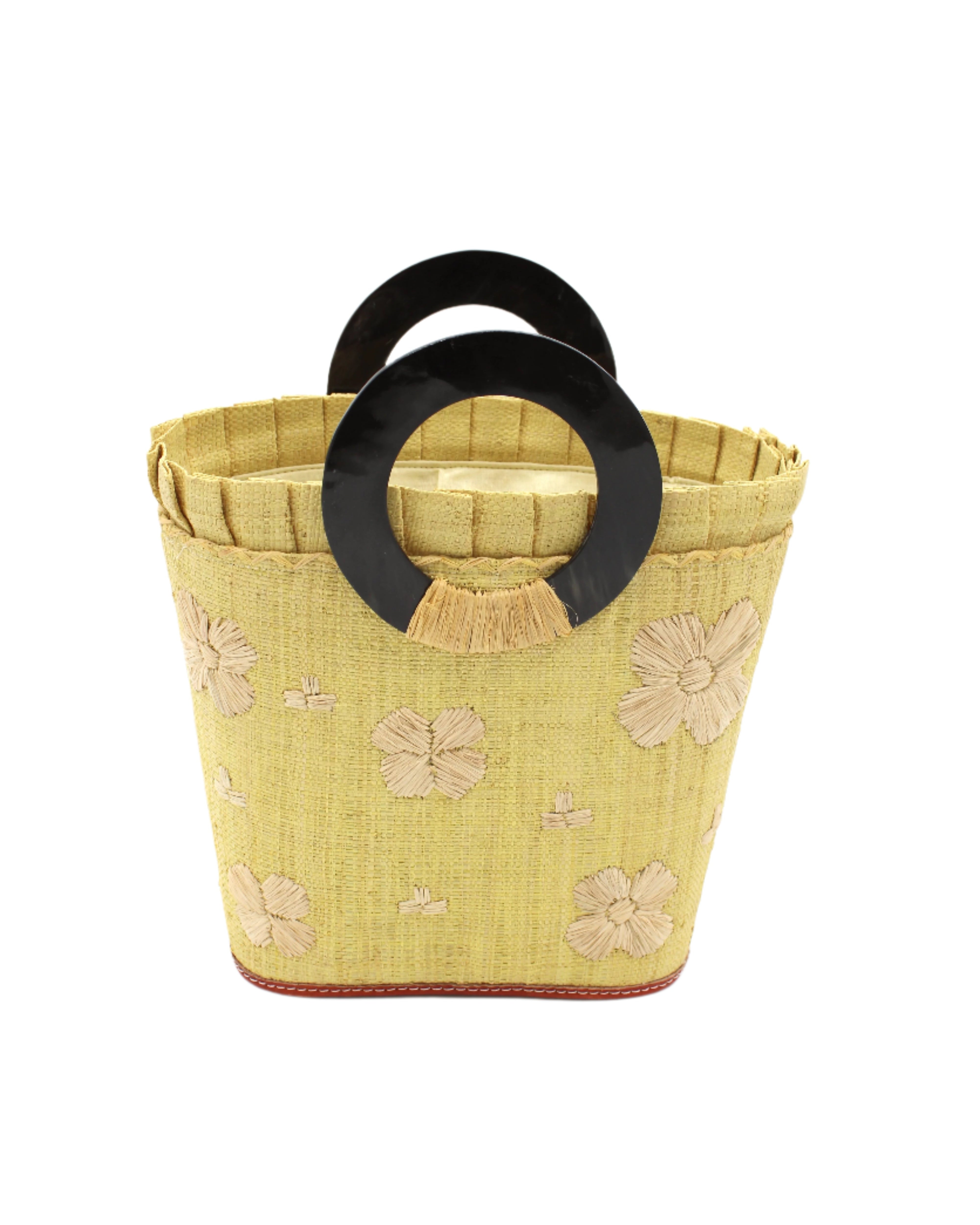 Tulum Straw Bucket Bag with Flower Embroidery and Horn Handle Butter Purse with Ruffle Edge handmade loomed raffia palm fiber in a solid hue of butter light/yellow with natural straw color hand embroidered floral pattern with multiple sized flowers and raffia ruffle on the opening handbag - Shebobo