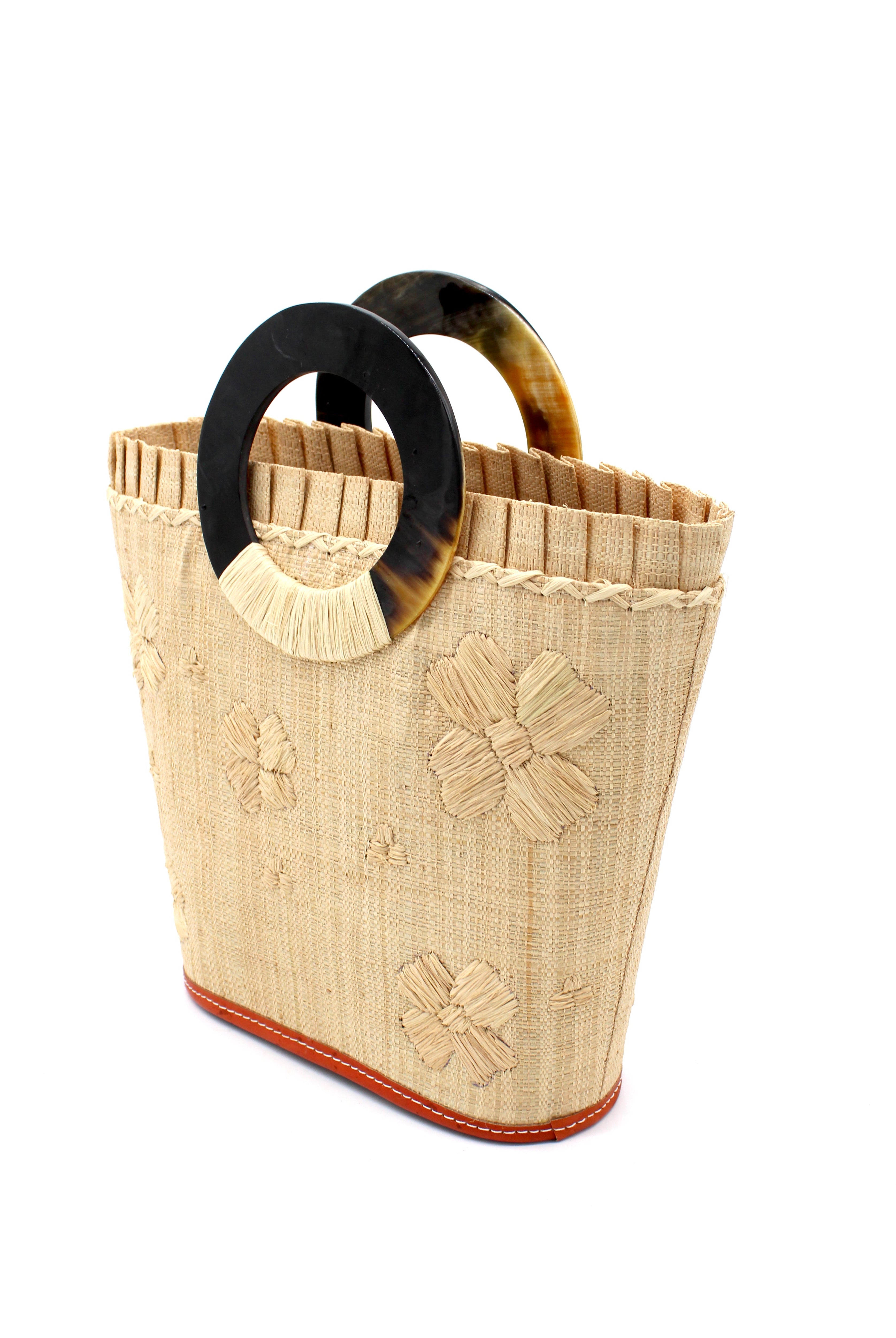 Side View Tulum Straw Bucket Bag with Flower Embroidery and Horn Handle Natural Purse with Ruffle Edge handmade loomed raffia palm fiber in a solid hue of natural straw color with matching subtle hand embroidered floral pattern with multiple sized flowers and raffia ruffle on the opening handbag - Shebobo