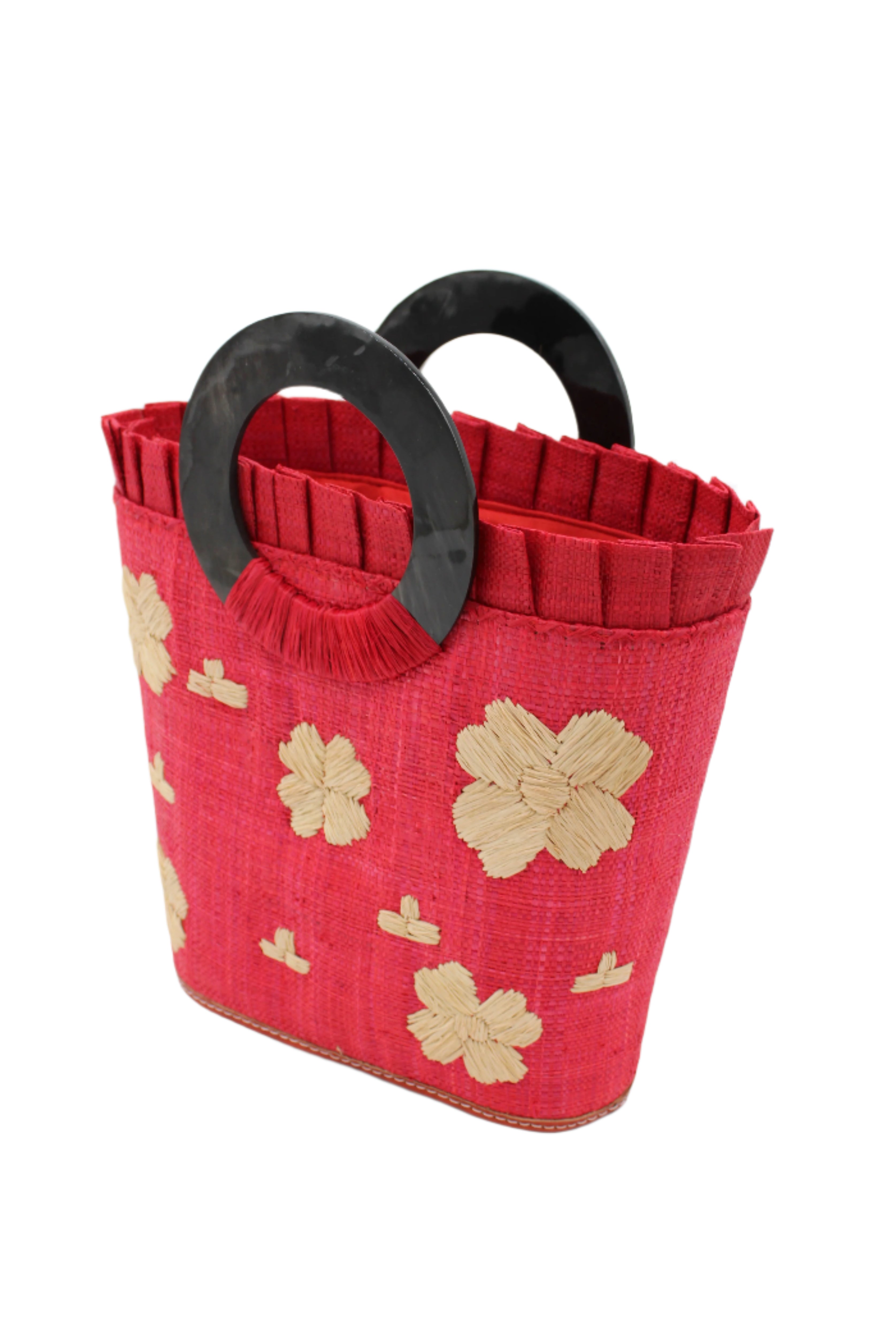 Side view Tulum Straw Bucket Bag with Flower Embroidery and Horn Handle Red Purse with Ruffle Edge handmade loomed raffia palm fiber in a solid hue of red with natural straw color hand embroidered floral pattern with multiple sized flowers and raffia ruffle on the opening handbag - Shebobo